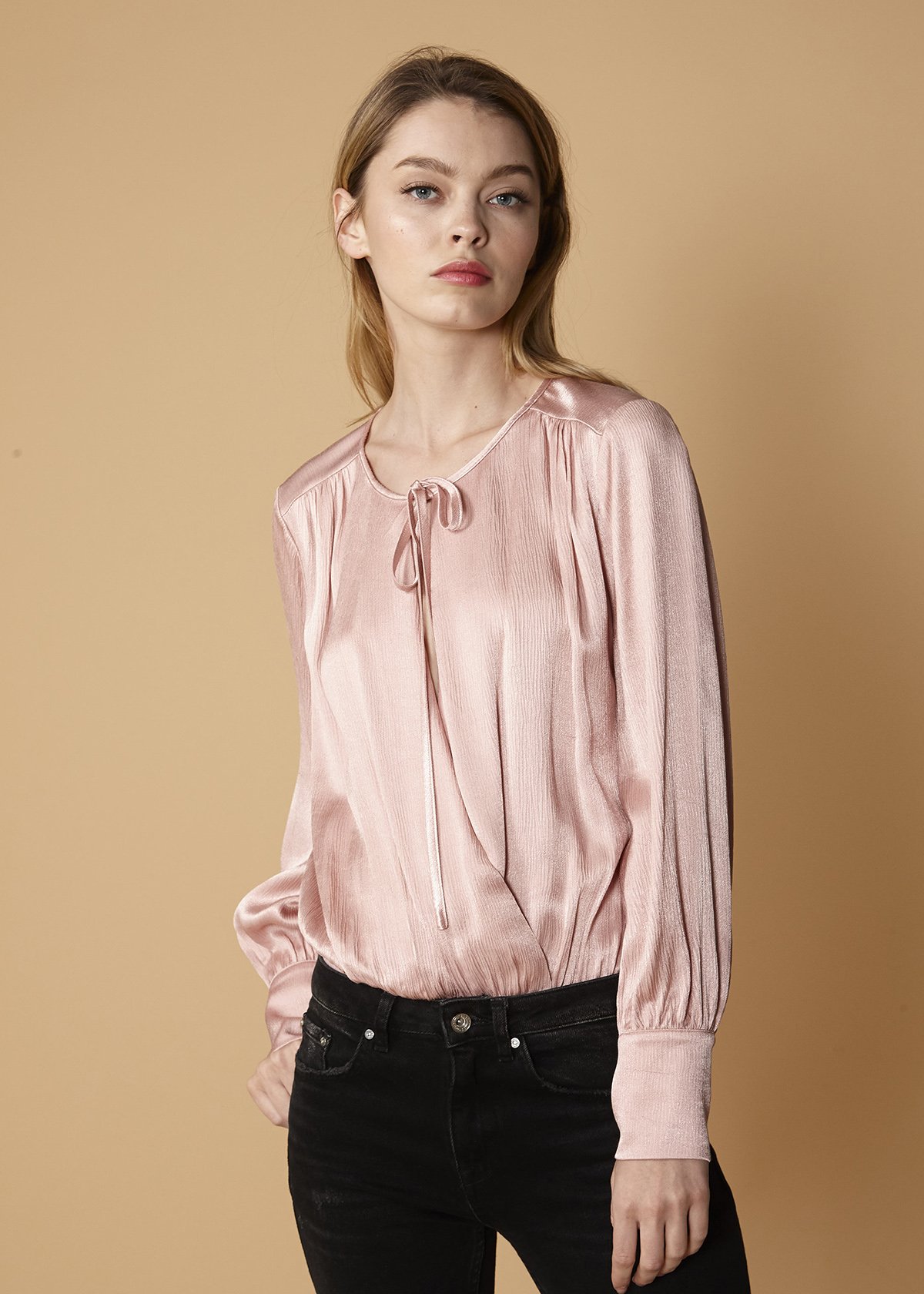 A stylish Tie-Neck Long Sleeve Bodysuit in Fall Pink, featuring a soft rayon fabric and a chic tie-neck design, perfect for autumn fashion.