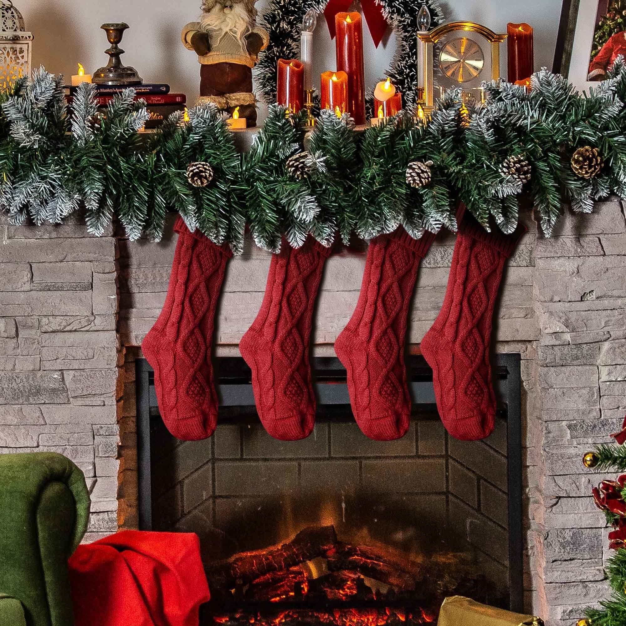 Set of 4 burgundy red Christmas stockings with chunky knit pattern, perfect for holiday decorations and gift stuffing.