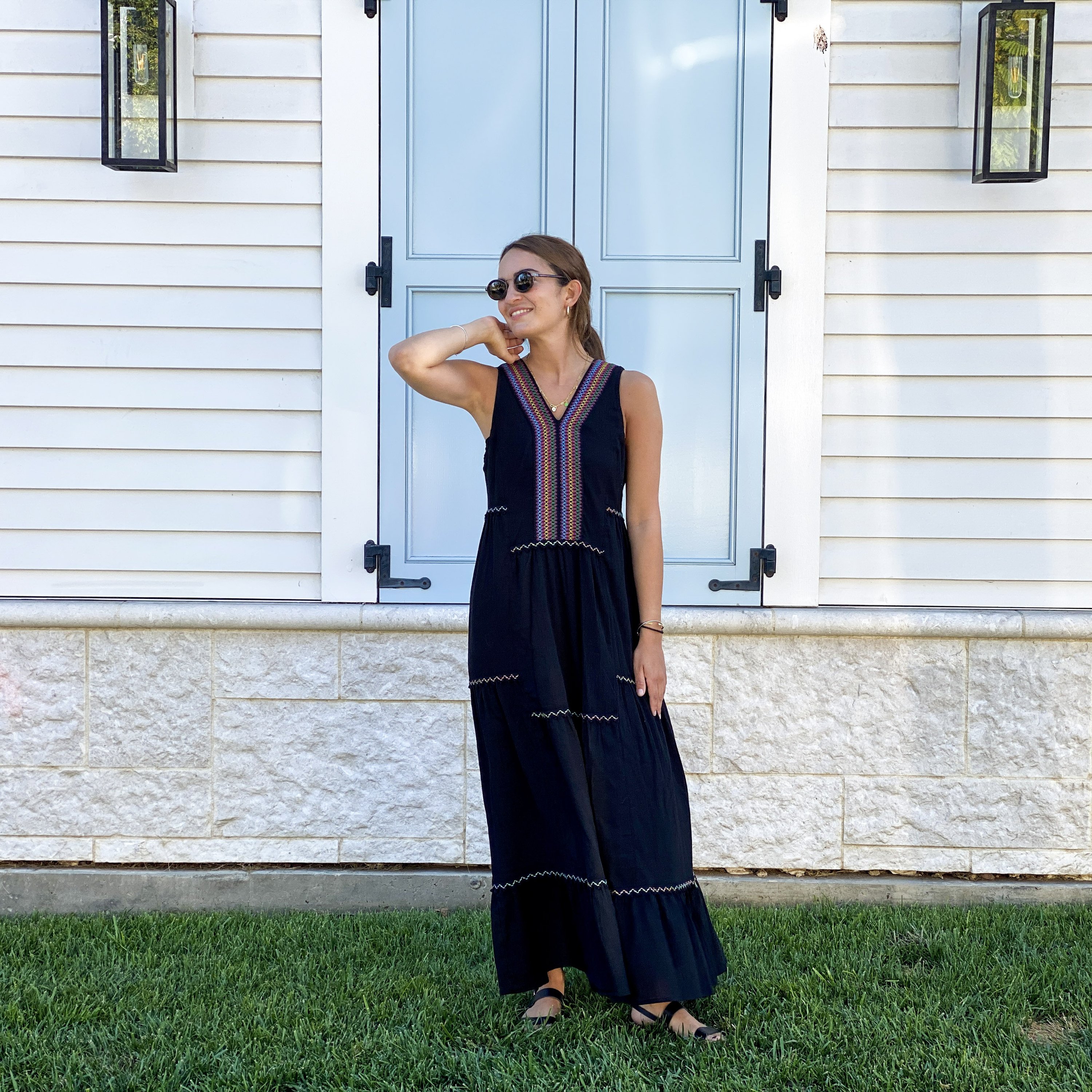 Black Amalfi Maxi Dress featuring colorful bohemian embroidery on breathable cotton fabric, with a tiered hem and loose fit.