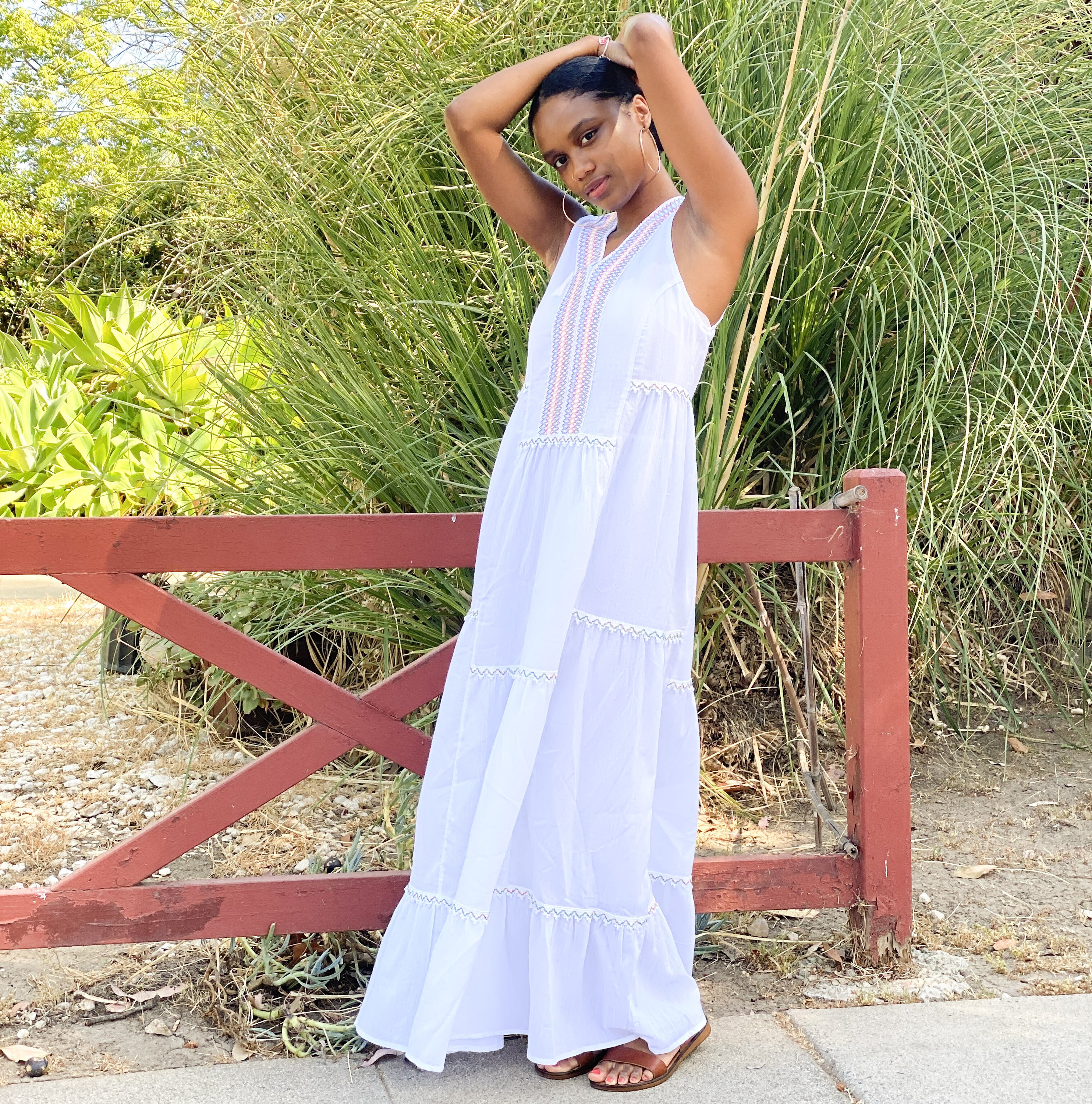 Amalfi Maxi Dress in white featuring colorful bohemian embroidery and a tiered hem, made from breathable cotton fabric.