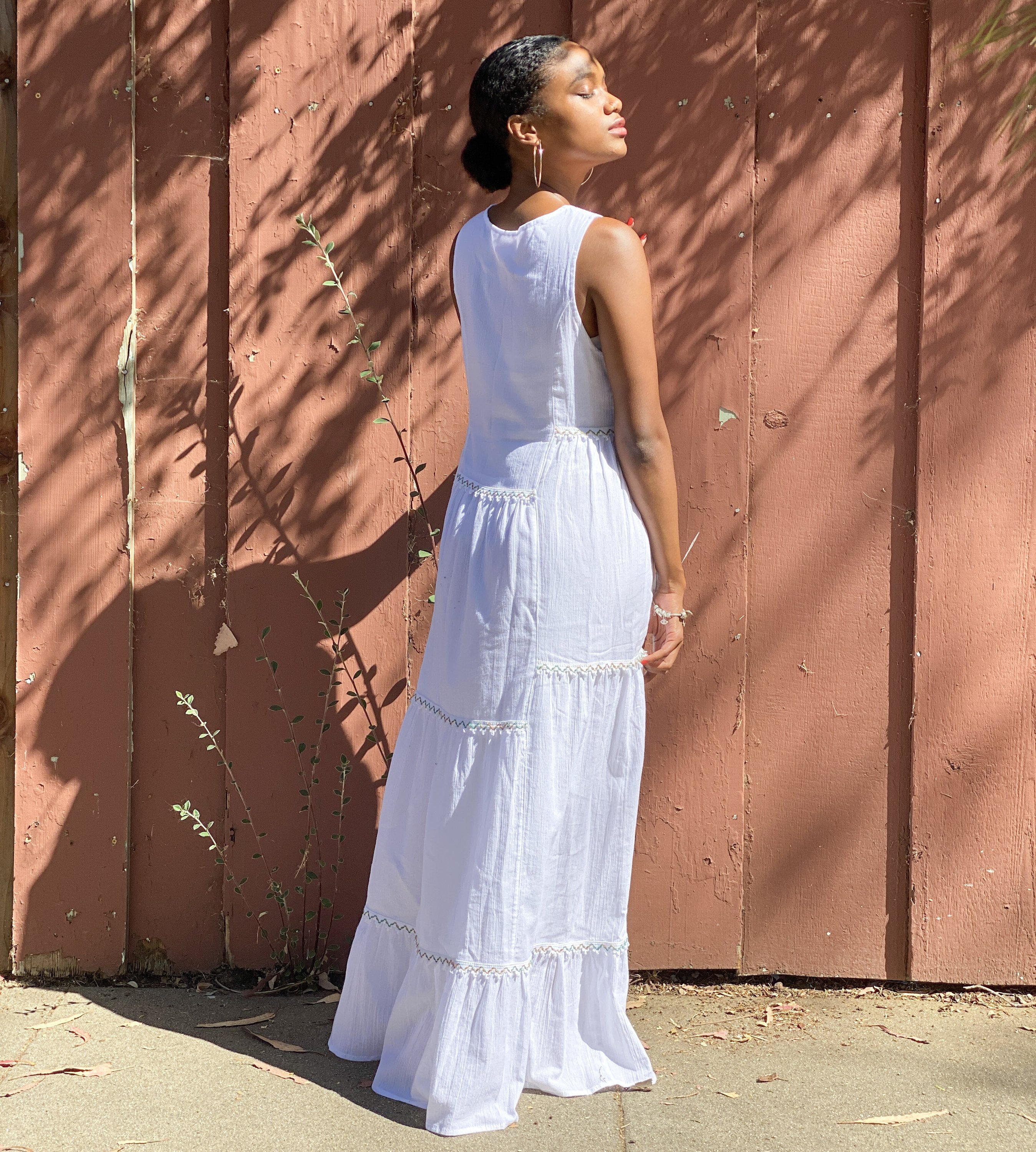 Amalfi Maxi Dress in white featuring colorful bohemian embroidery and a tiered hem, made from breathable cotton fabric.