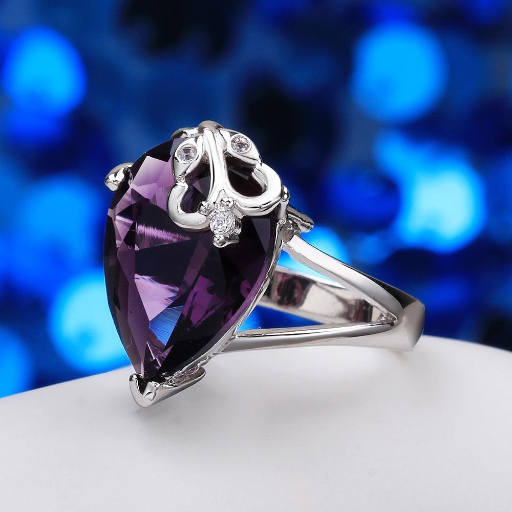 Amethyst pear cut ring set in 18K white gold, showcasing a vibrant purple gemstone with a sleek and elegant design.