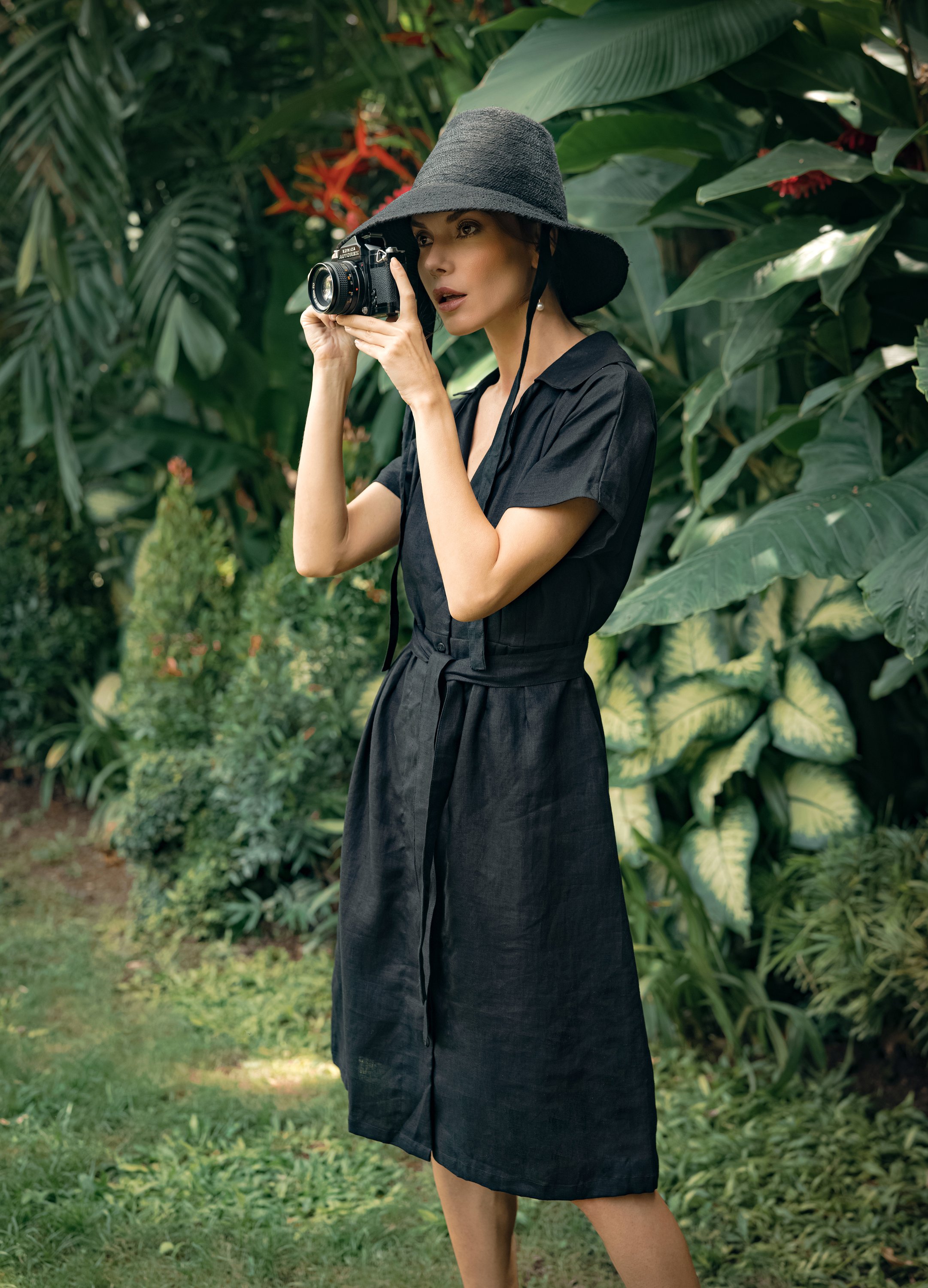 ARYA Safari Linen Midi Dress in Black, showcasing its elegant design, button-down closure, and spacious side pockets.