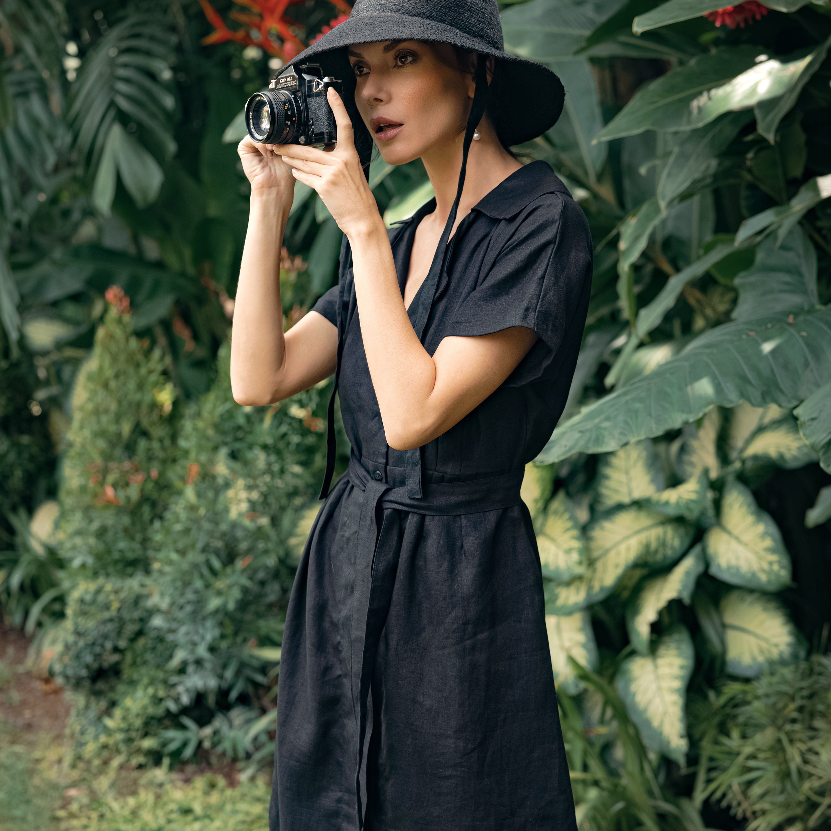 ARYA Safari Linen Midi Dress in Black, showcasing its elegant design, button-down closure, and spacious side pockets.