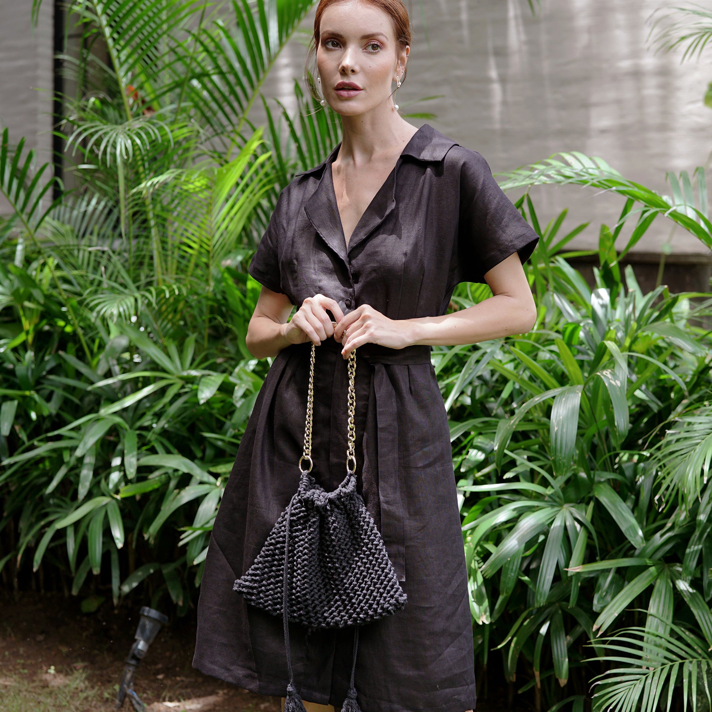 ARYA Safari Linen Midi Dress in Black, showcasing its elegant design, button-down closure, and spacious side pockets.