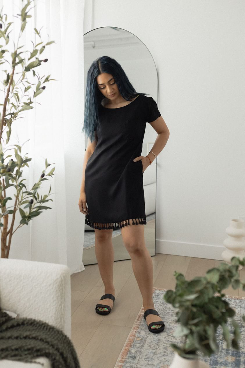 A stylish Beach T-Shirt Dress featuring a scoop neck, pleated short sleeves, side pockets, and a fringe hemline, perfect for summer outings.