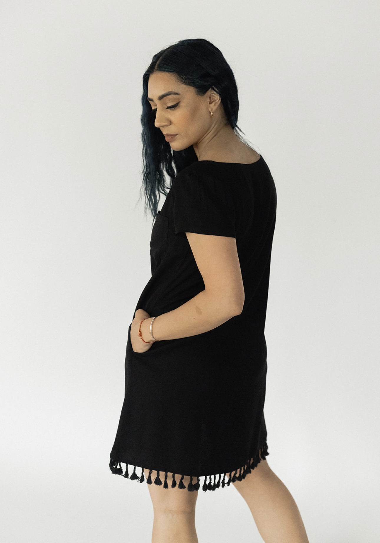 A stylish Beach T-Shirt Dress featuring a scoop neck, pleated short sleeves, side pockets, and a fringe hemline, perfect for summer outings.