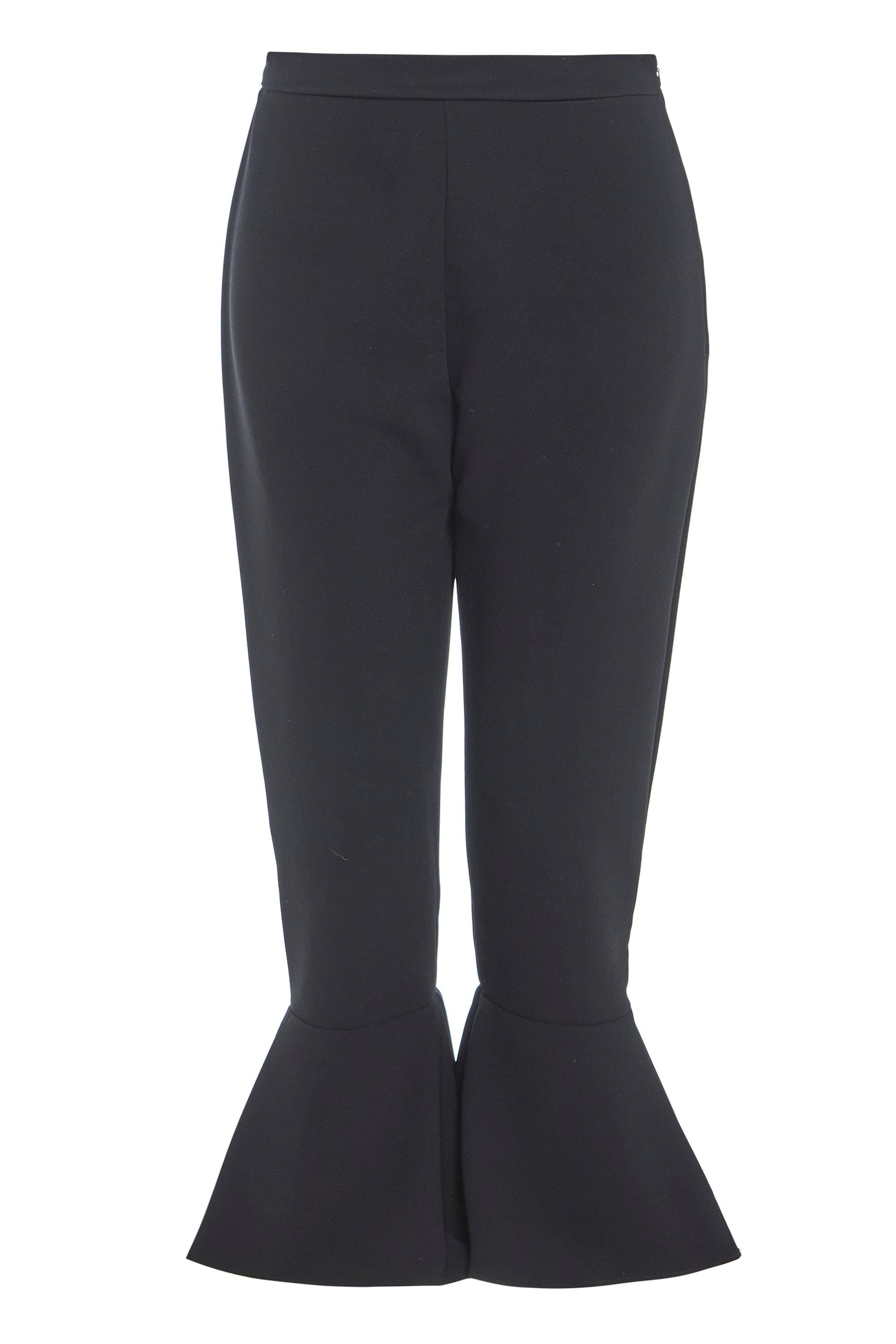 Elegant black frill hem trousers with a high waist and side zip closure, showcasing a stylish frill detail at the hem.