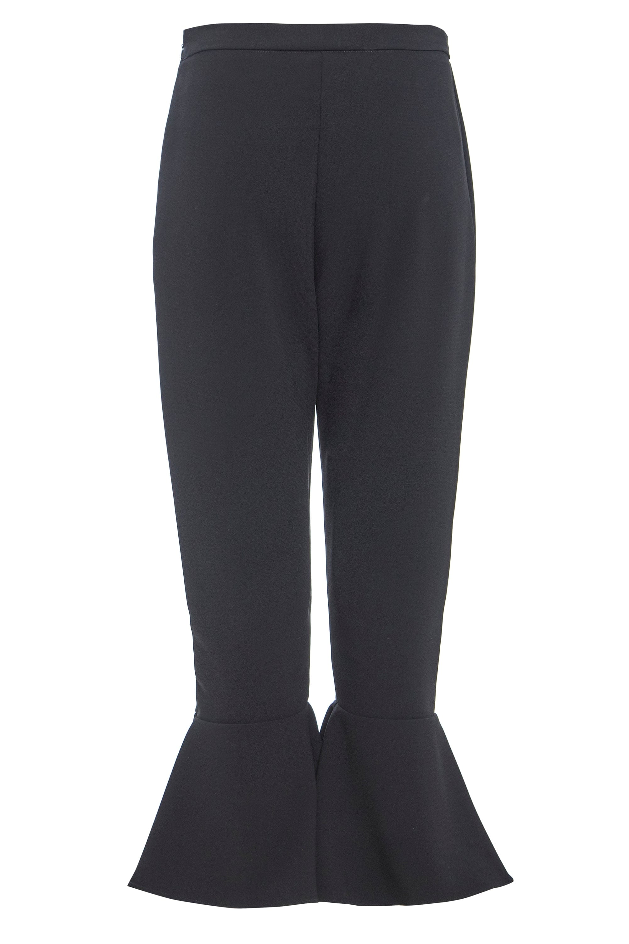 Elegant black frill hem trousers with a high waist and side zip closure, showcasing a stylish frill detail at the hem.