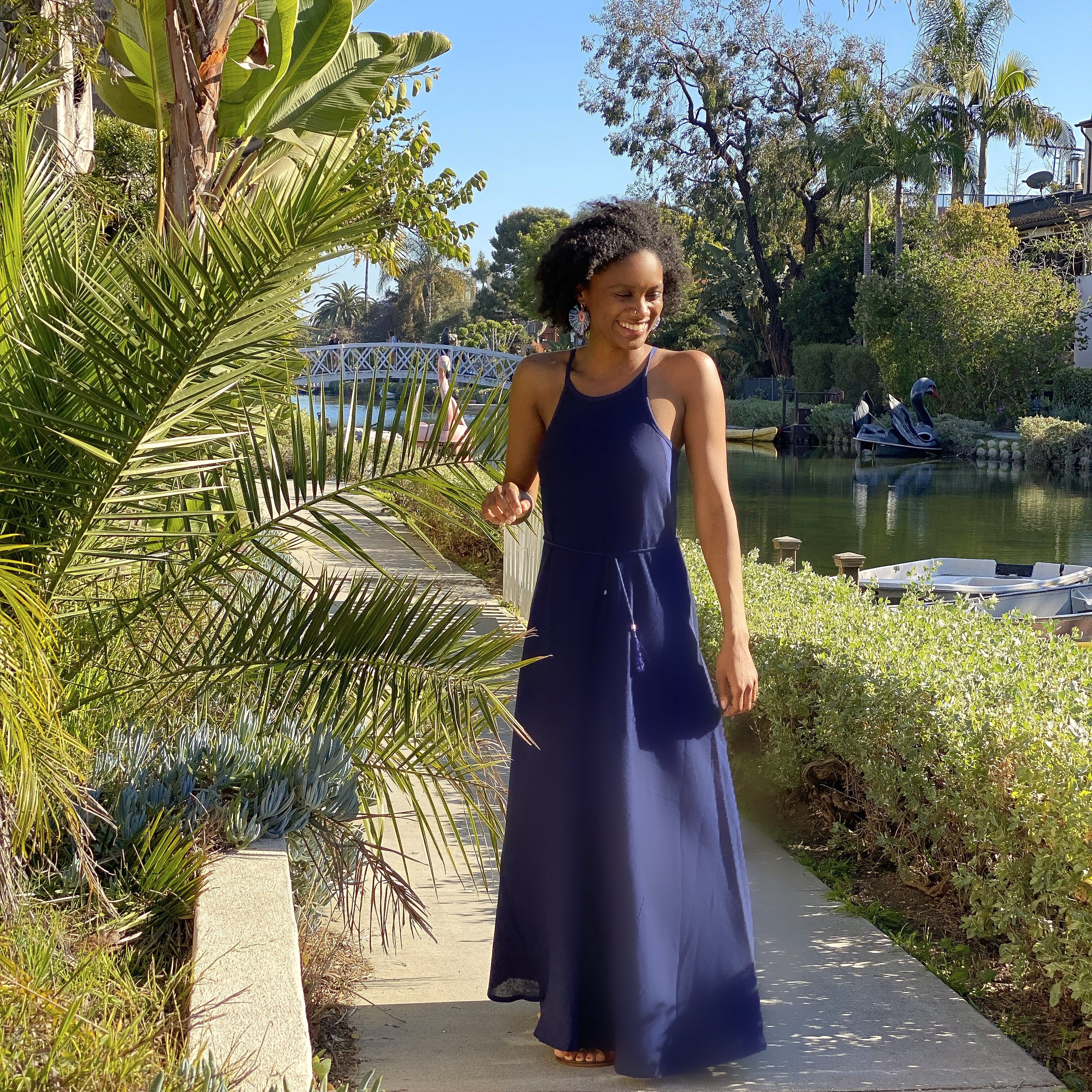 Callie Maxi Dress in black featuring narrow straps and tassel waist ties, perfect for summer outings.