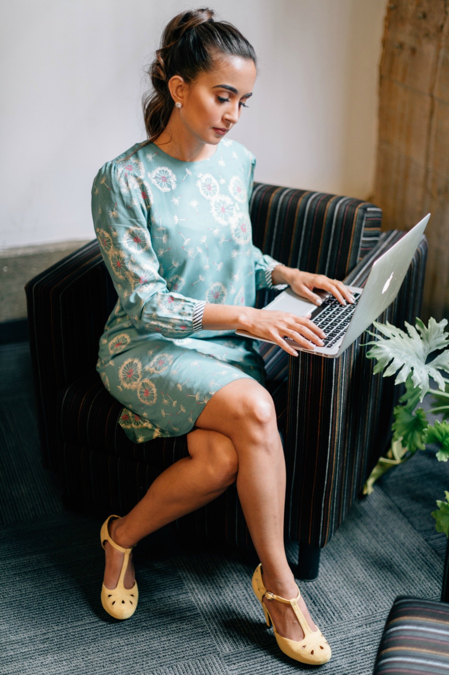 A stylish Dancing Dandelion Dress featuring a playful dandelion print, keyhole back, and soft fabric, perfect for work or casual outings.