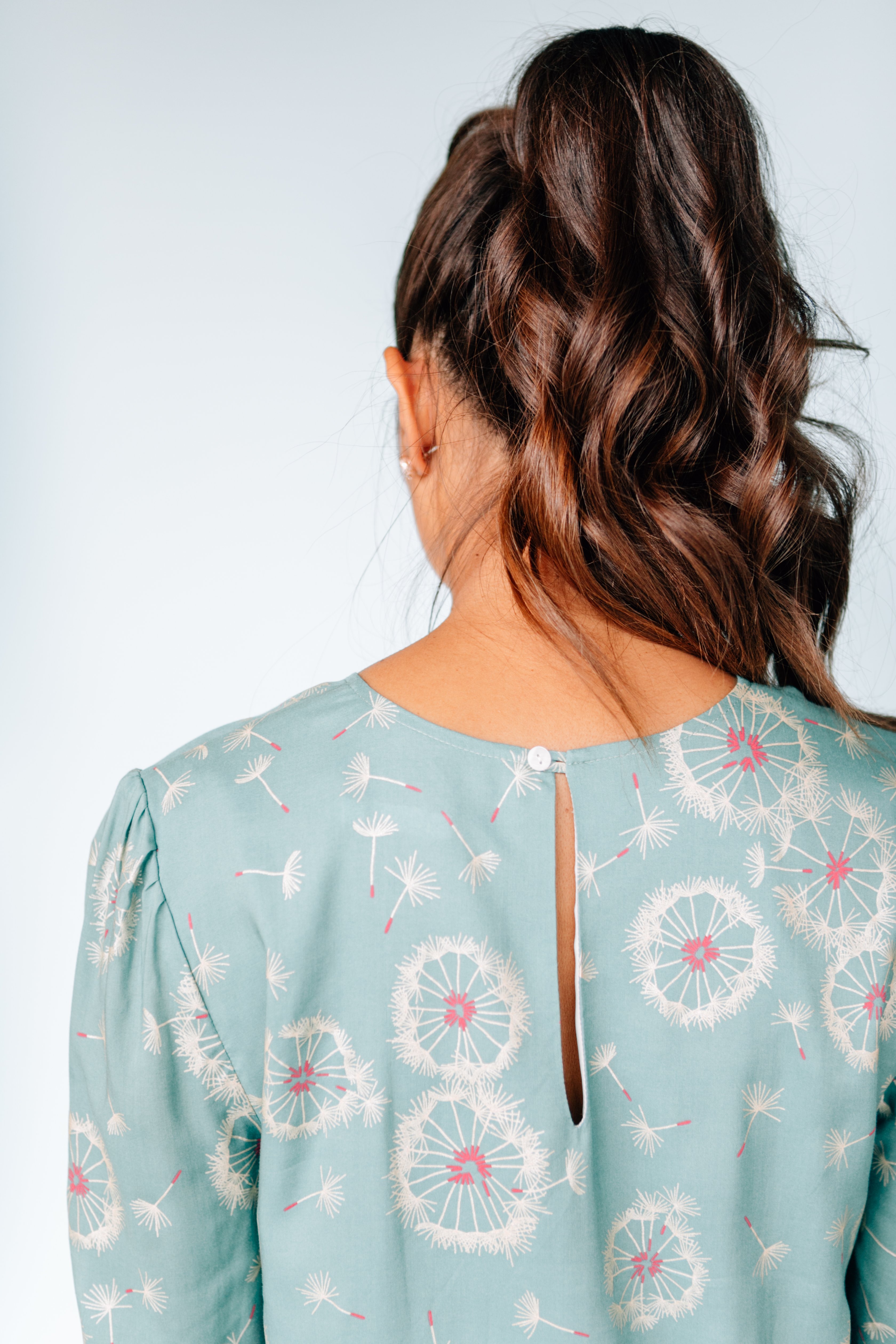 A stylish Dancing Dandelion Dress featuring a playful dandelion print, keyhole back, and soft fabric, perfect for work or casual outings.