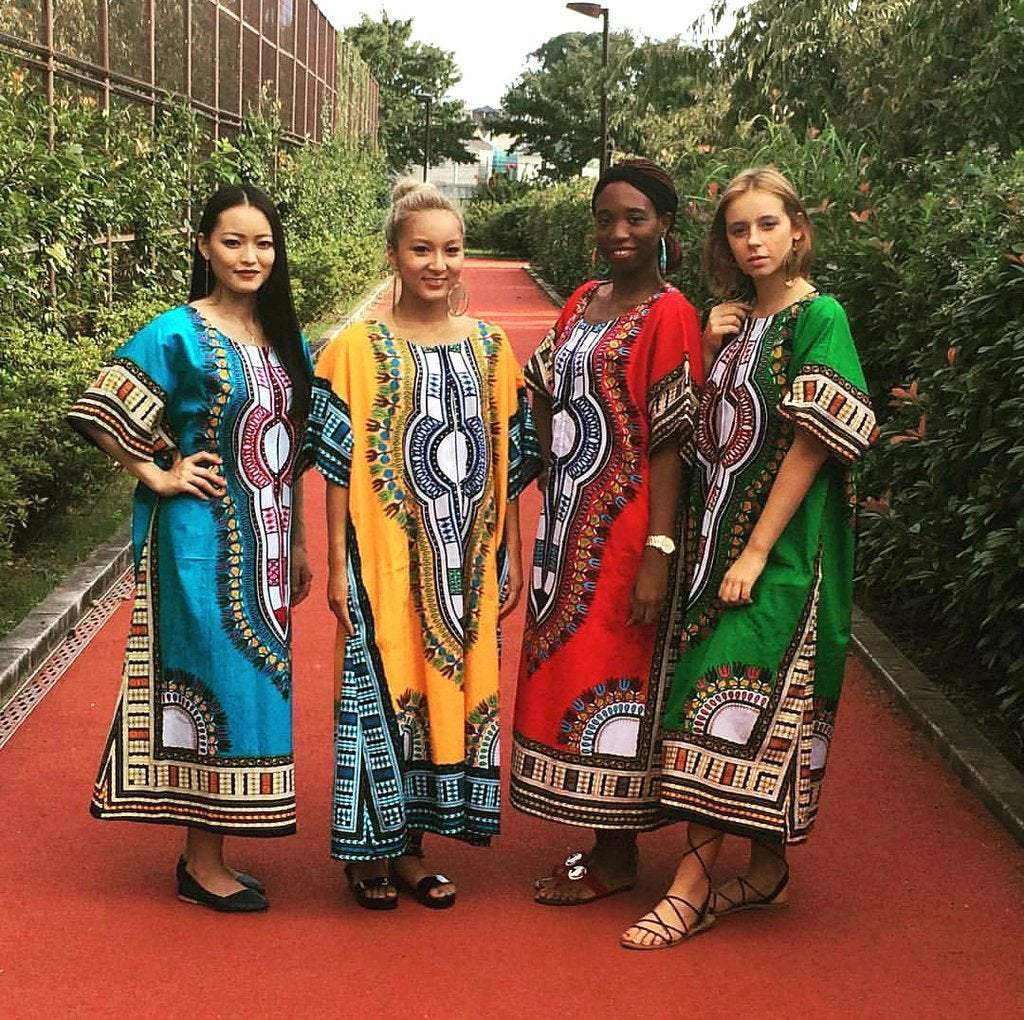 A vibrant orange Dashiki Maxi African Dress featuring traditional prints, showcasing its comfortable and stylish design.