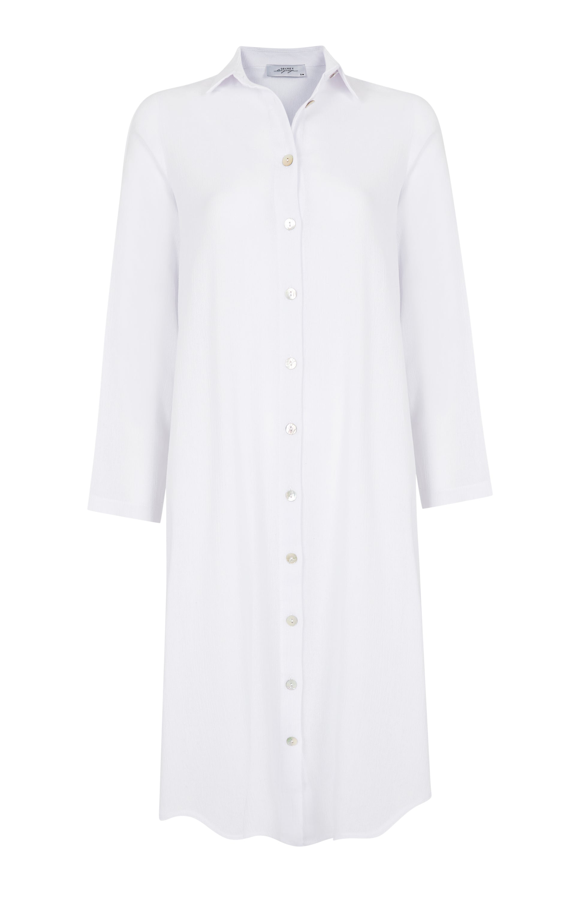 A stylish white Della shirt dress made from lightweight cotton-voile, featuring lustrous buttons and a loose fit, perfect for warm weather.