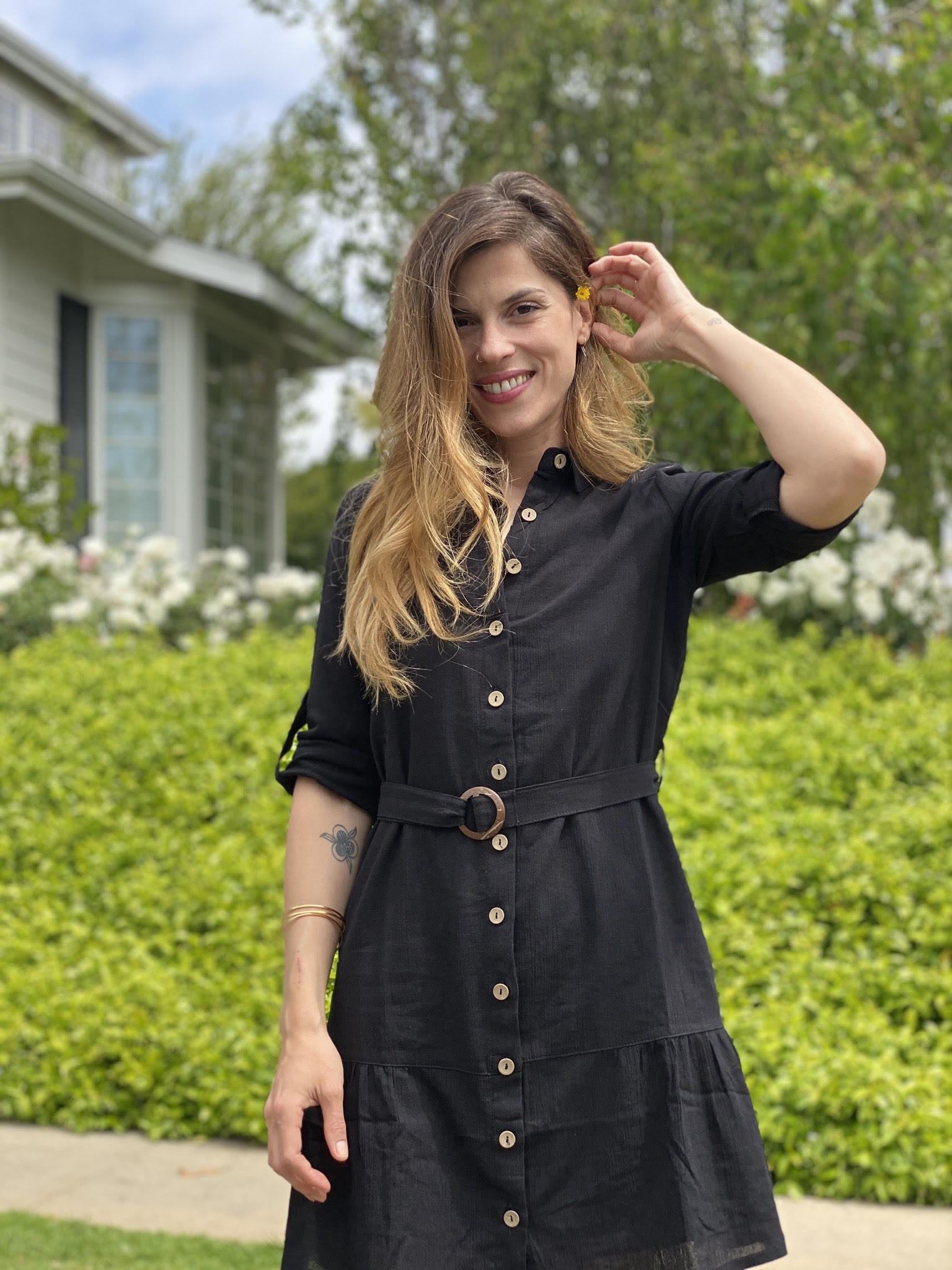 A stylish black cotton shirt dress with an O-ring belt and flared mini skirt, perfect for casual outings.