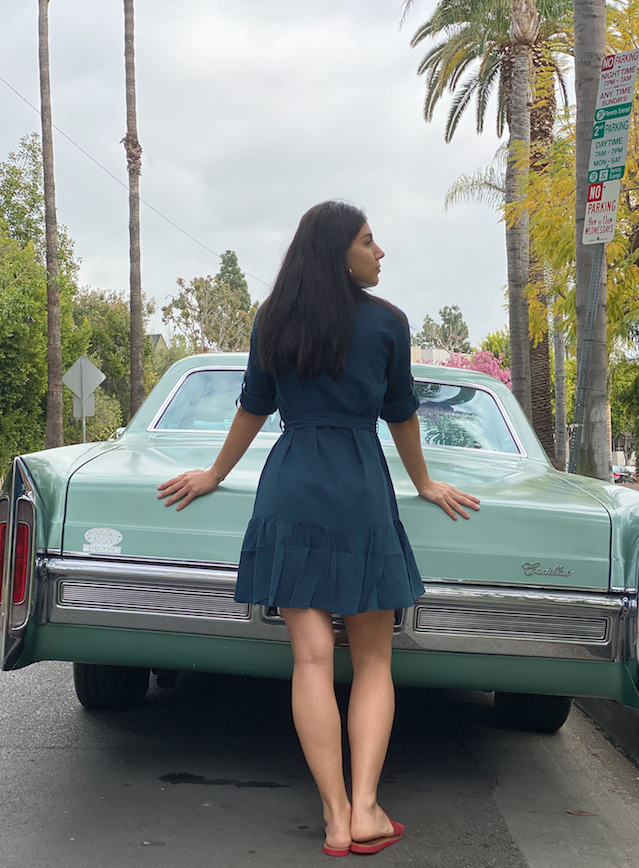 A stylish petrol-colored shirt dress with an O-ring belt, featuring a slightly loose fit and a flared mini skirt, perfect for summer outings.