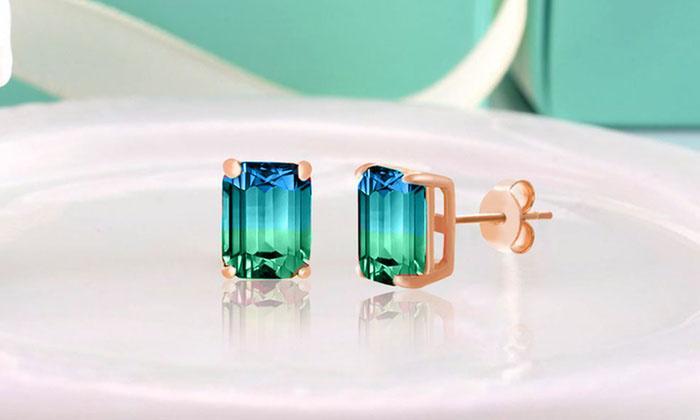 Emerald cut sapphire and aquamarine stud earrings set in 18K rose gold, showcasing their elegant design and brilliant gemstones.