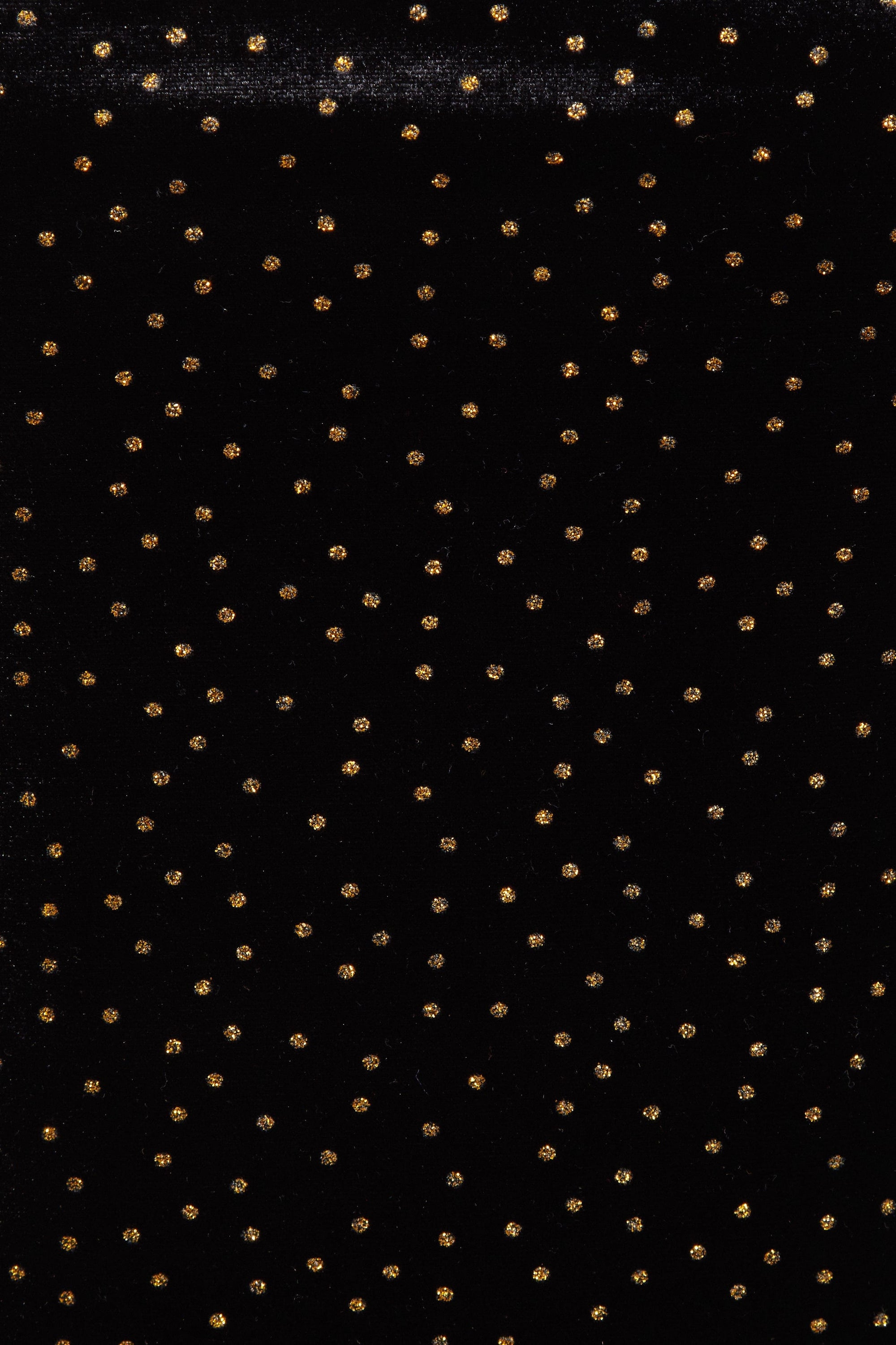 SIMA Gold Polka Dot Dress featuring a fitted silhouette, scooping neckline, and shimmering black velvet fabric with gold polka dots.