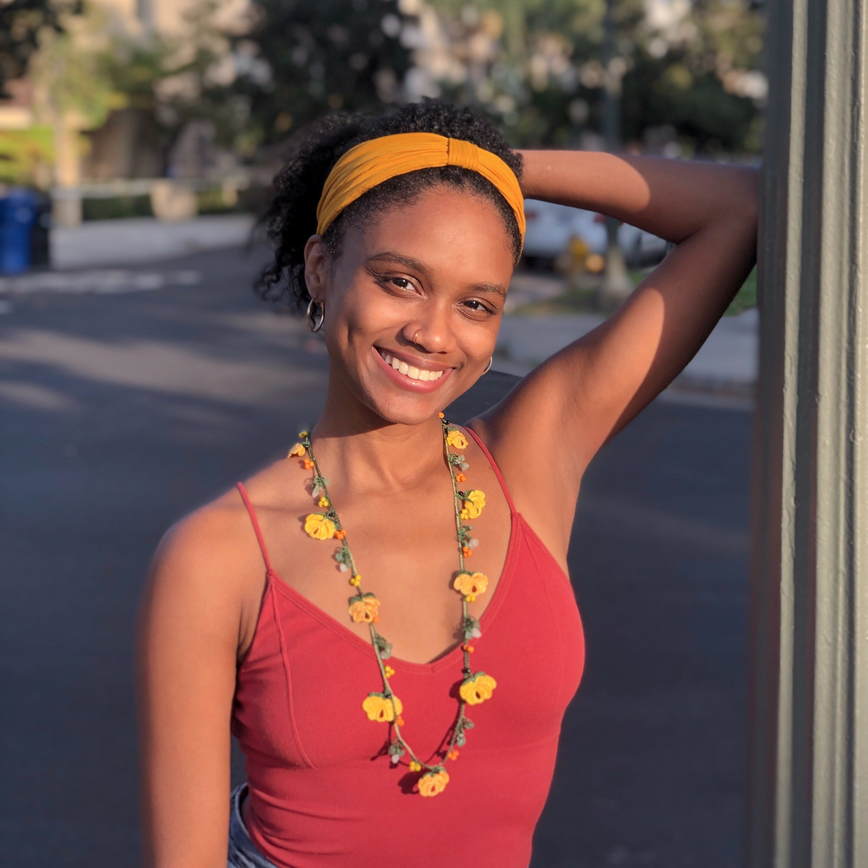 Grace Long Necklace featuring orange and yellow floral embroidery, handmade by female artisans in Turkey, with a secure stone fastening.