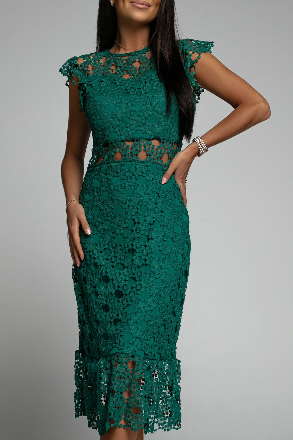 A beautiful green midi dress featuring lace lining, floral crochet details, and a ruffled hemline, perfect for parties and special occasions.