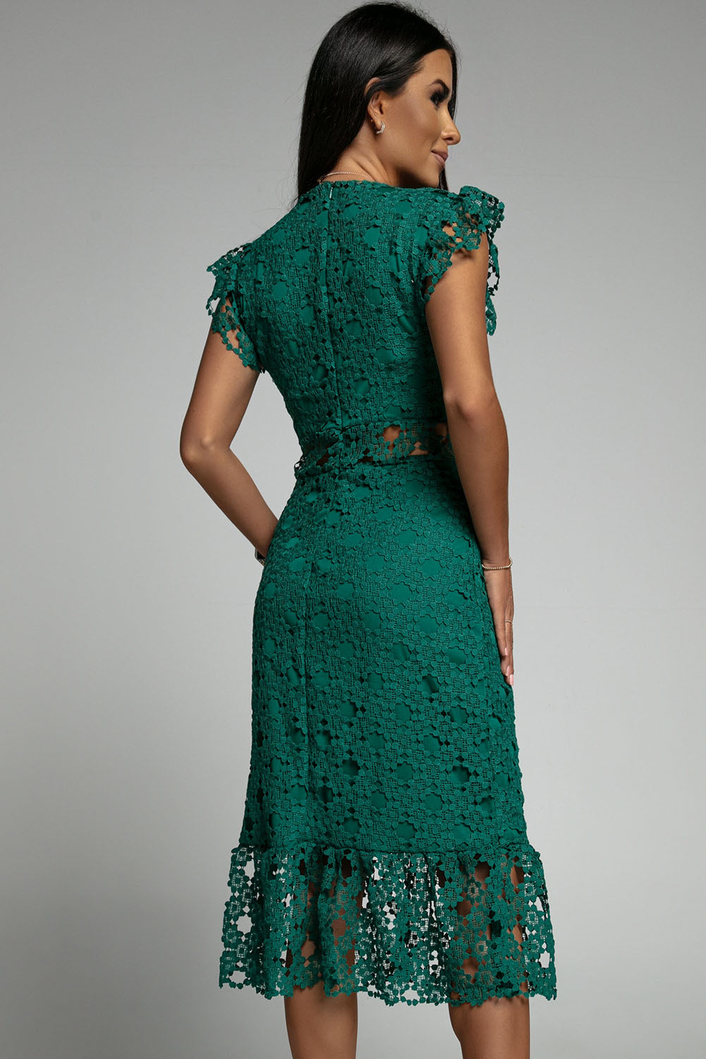 A beautiful green midi dress featuring lace lining, floral crochet details, and a ruffled hemline, perfect for parties and special occasions.