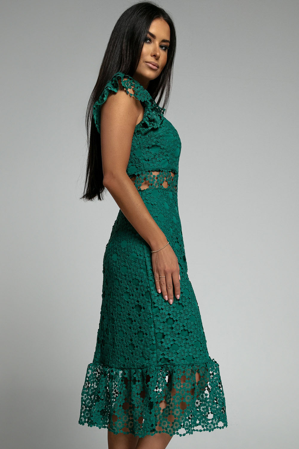 A beautiful green midi dress featuring lace lining, floral crochet details, and a ruffled hemline, perfect for parties and special occasions.