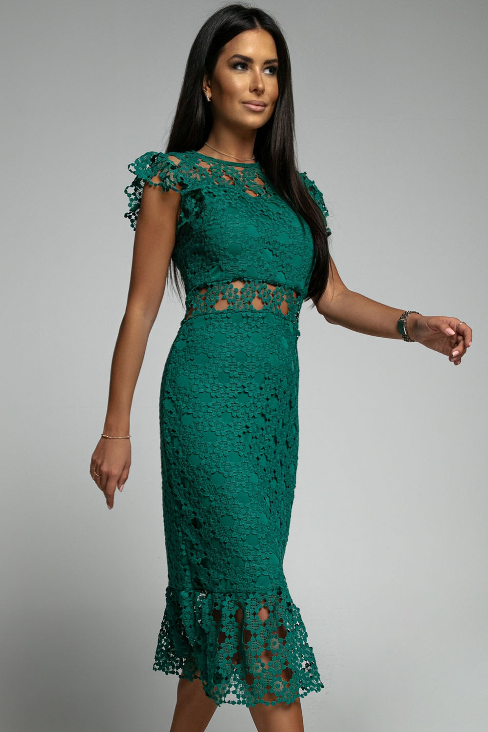 A beautiful green midi dress featuring lace lining, floral crochet details, and a ruffled hemline, perfect for parties and special occasions.