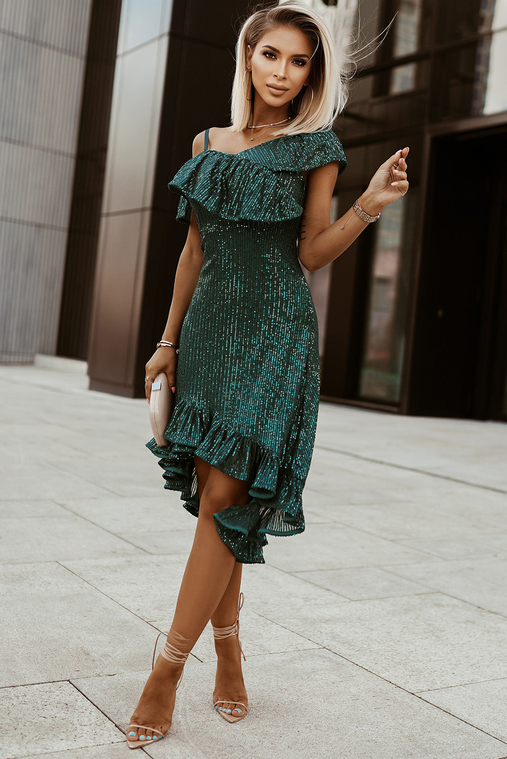 A glamorous green one-shoulder sequin dress featuring ruffled neckline and high-low hem, perfect for parties and formal events.