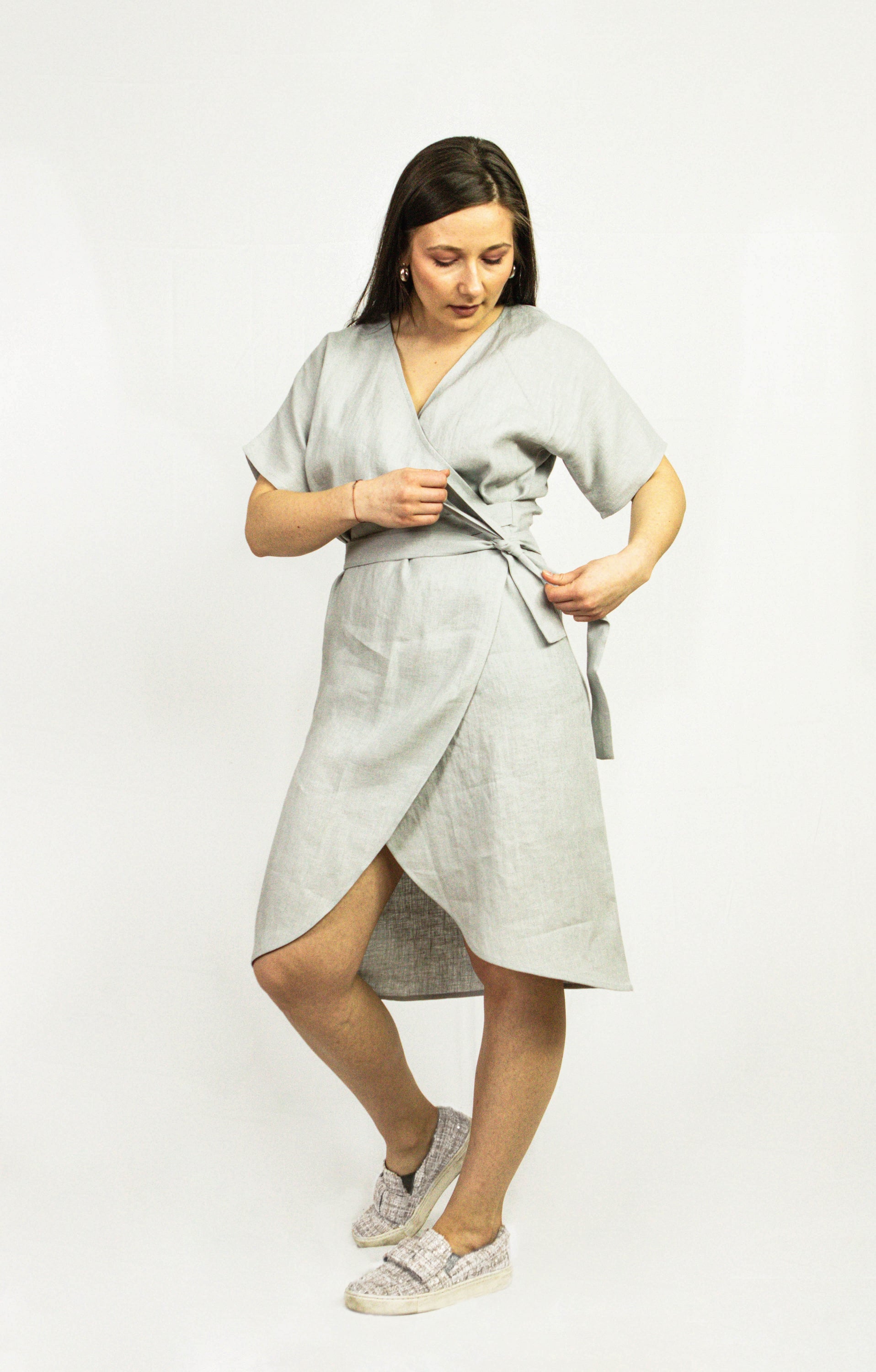 Light Grey linen wrap dress featuring a deep V-neckline, wide sleeves, and side pockets, made from eco-friendly European linen.