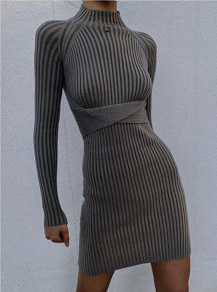 Malika Knit Dress featuring a mock neck, full-length sleeves, and an open back with a twist, designed to flatter the figure.