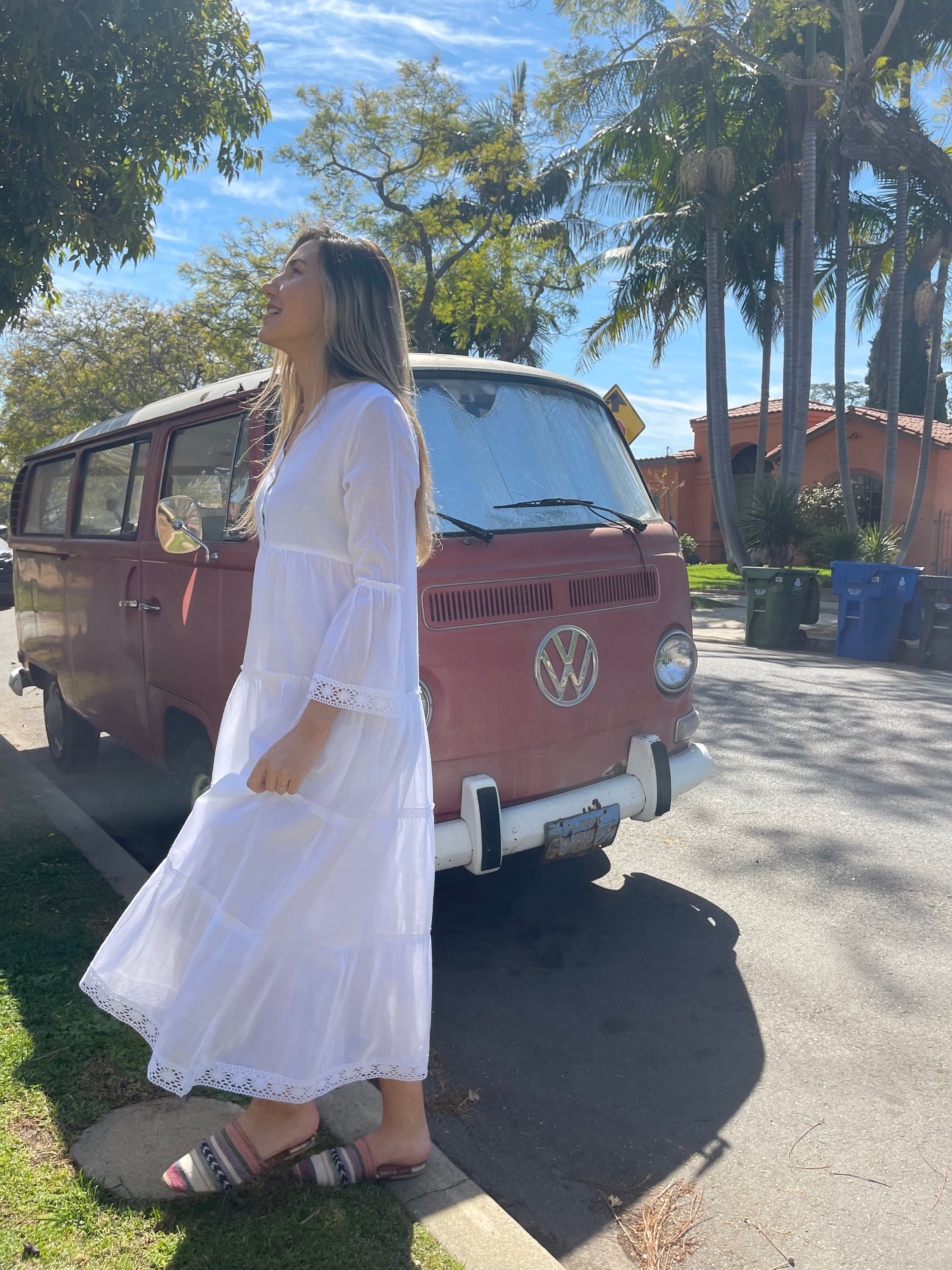 MIKA MAXI DRESS in white featuring a V-neckline and tiered skirt, made from 100% cotton-voile, perfect for warm weather.