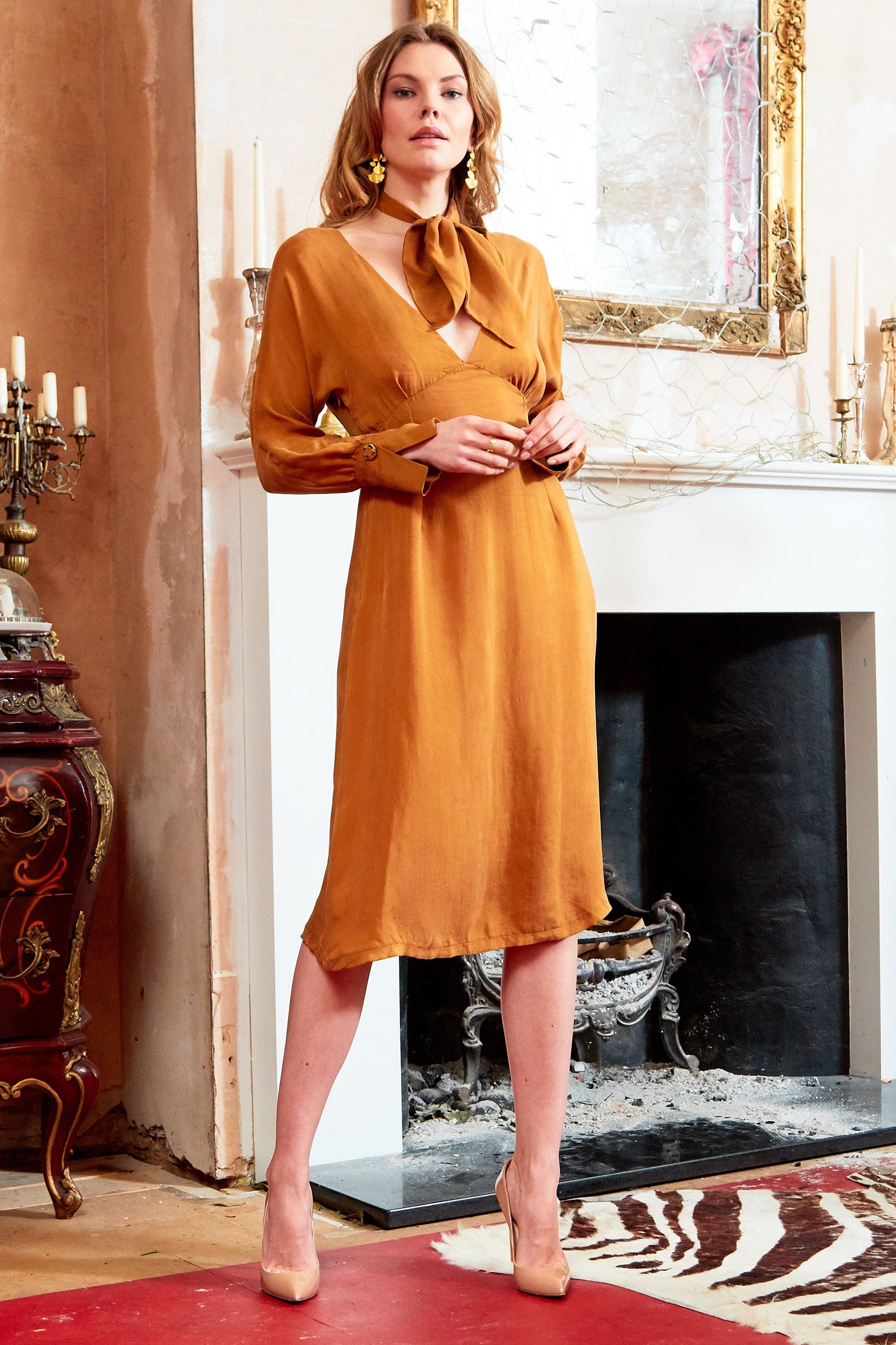 A stylish mustard long sleeve midi dress featuring bespoke gold buttons and a cinched waist, perfect for various occasions.