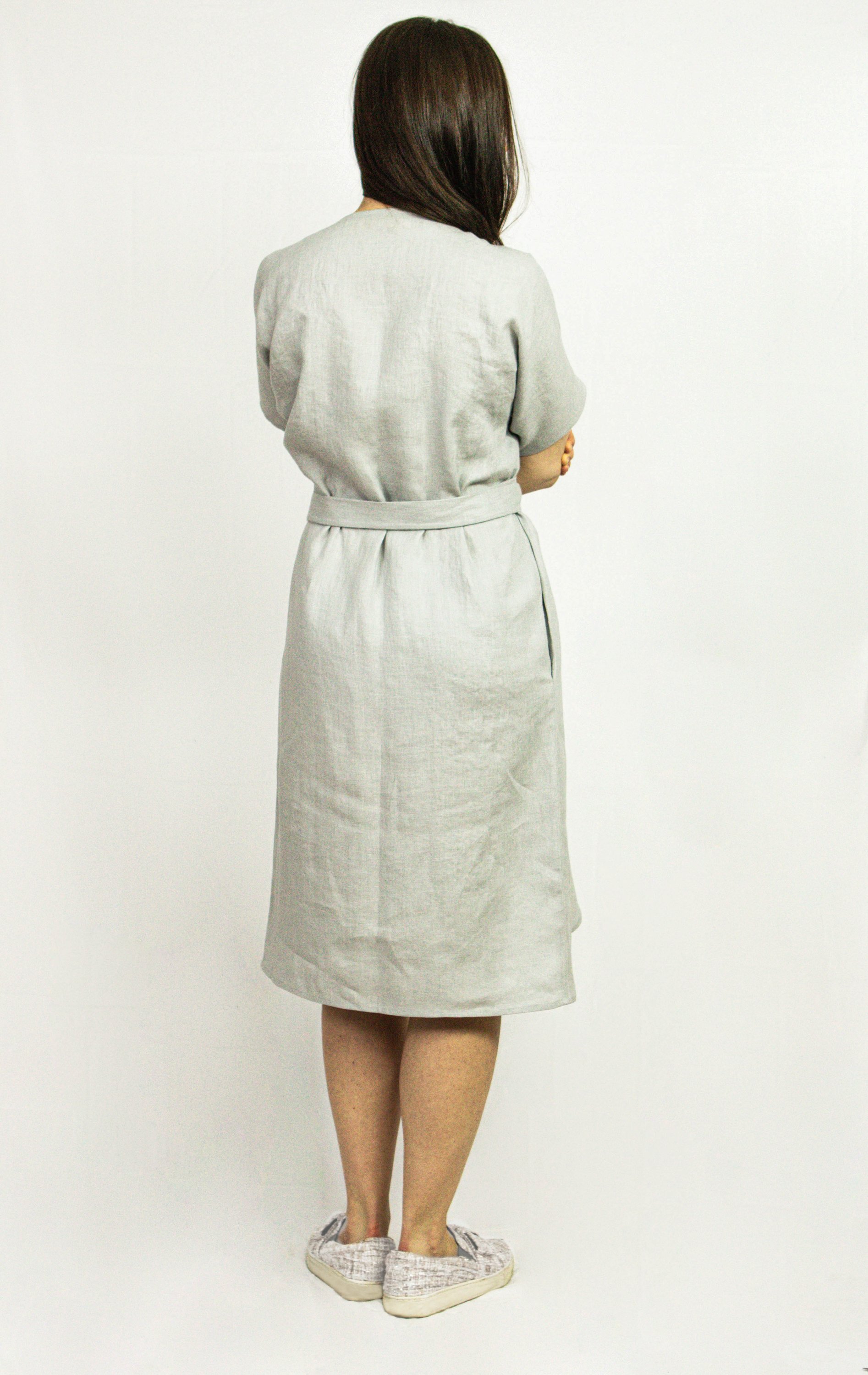 Natural Light linen wrap dress featuring a flowing design, wide sleeves, deep V-neckline, and side pockets, made from eco-friendly European linen.