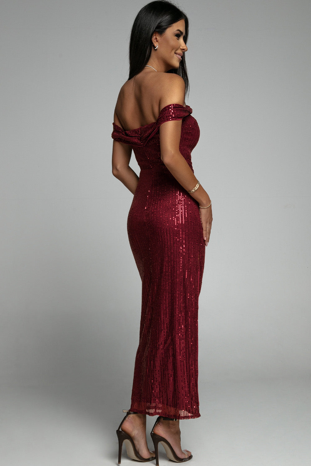 A glamorous off-shoulder sequin party dress featuring a bodycon fit and side slit, perfect for formal events.