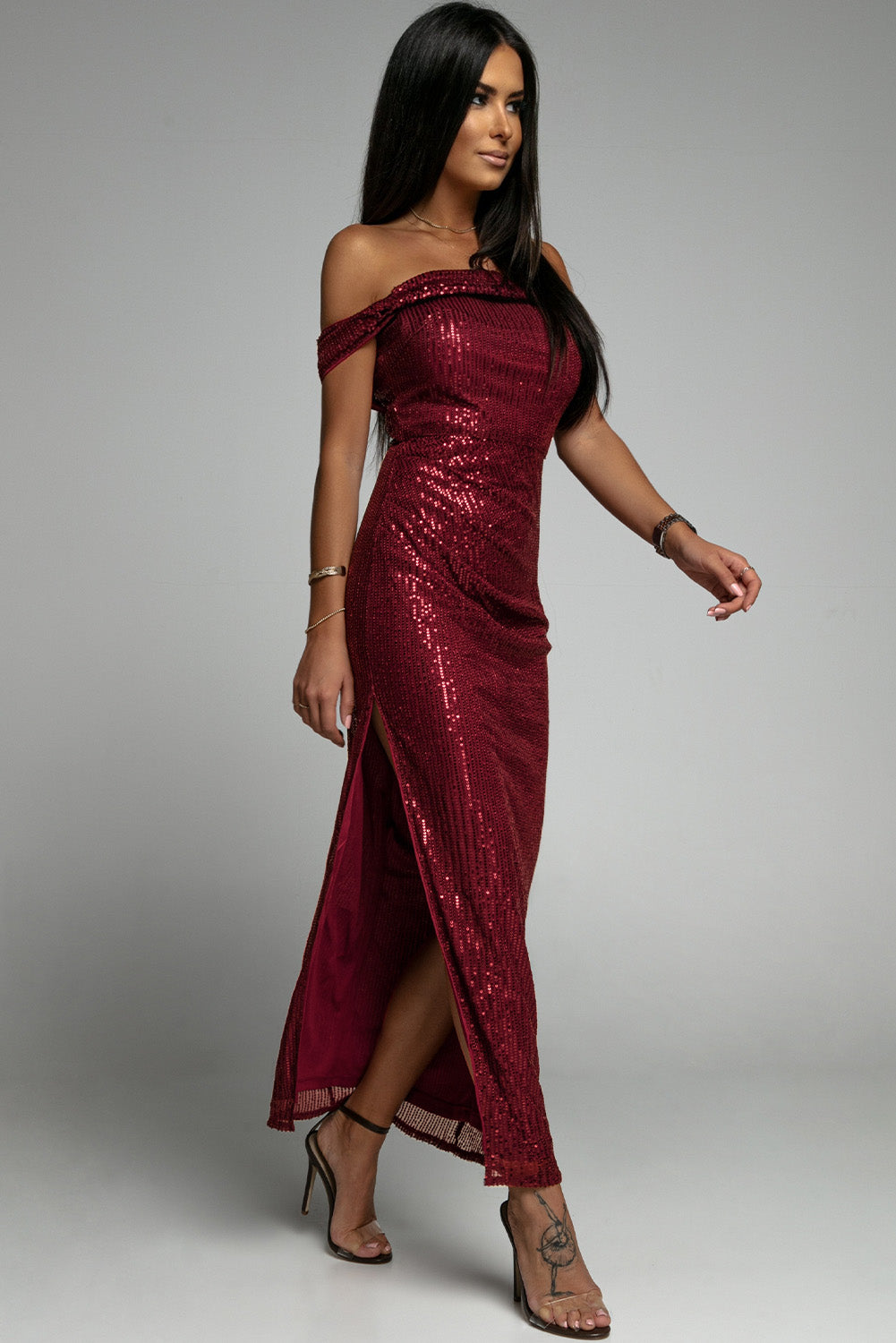 A glamorous off-shoulder sequin party dress featuring a bodycon fit and side slit, perfect for formal events.