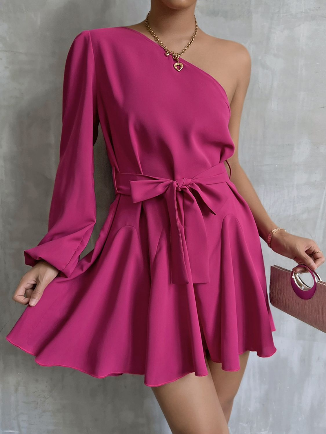 A stylish one-shoulder belted mini dress featuring puff long sleeves and a ruffle detail, perfect for cocktail events.