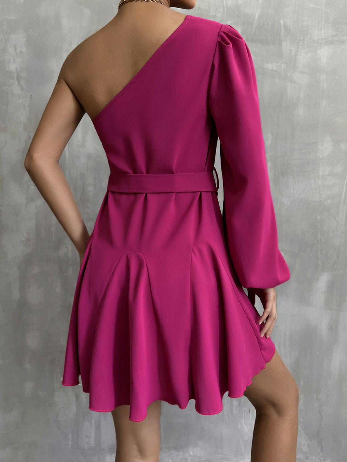 A stylish one-shoulder belted mini dress featuring puff long sleeves and a ruffle detail, perfect for cocktail events.