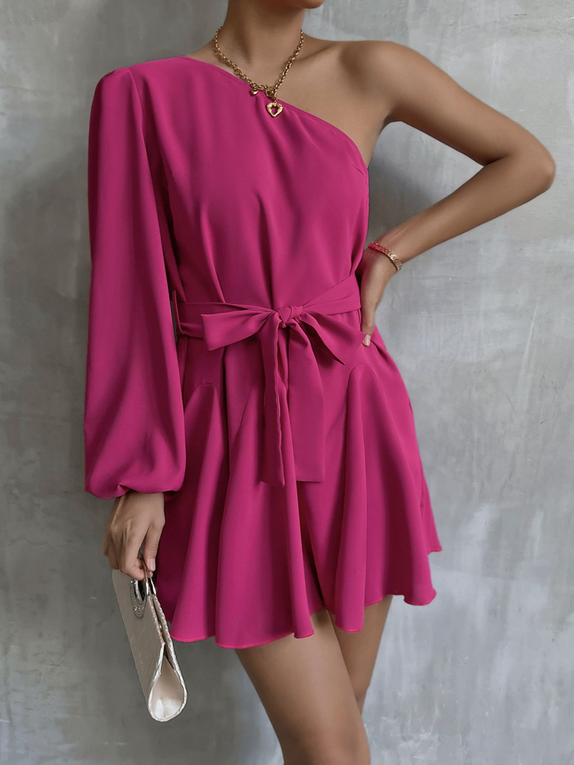 A stylish one-shoulder belted mini dress featuring puff long sleeves and a ruffle detail, perfect for cocktail events.