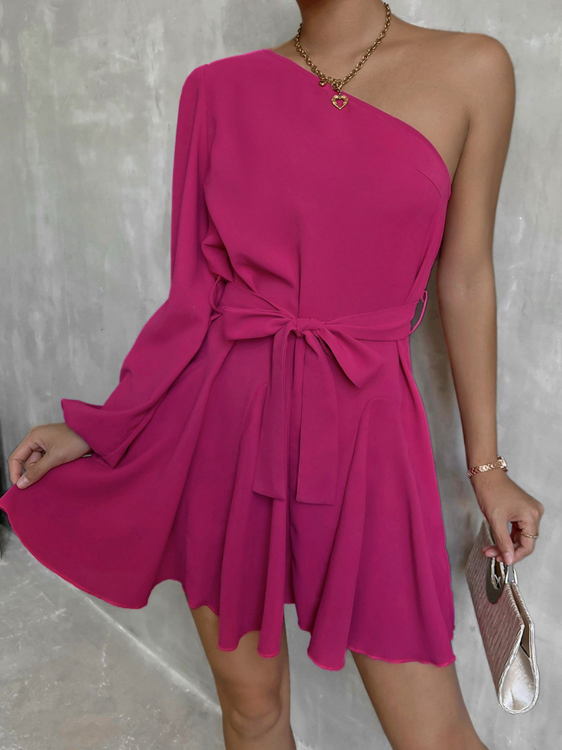 A stylish one-shoulder belted mini dress featuring puff long sleeves and a ruffle detail, perfect for cocktail events.