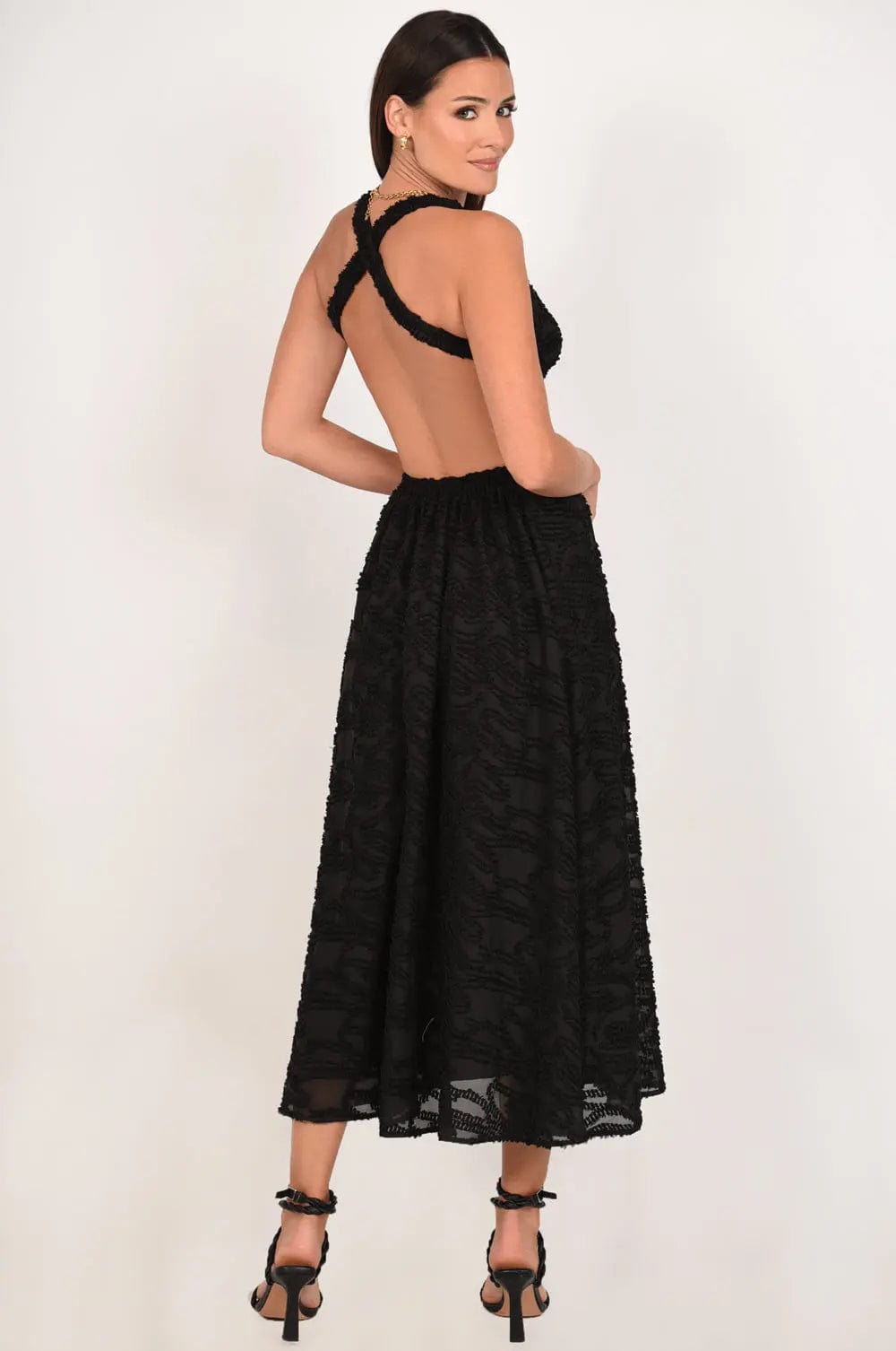 A stylish backless maxi dress featuring a low-cut back design, perfect for various occasions.