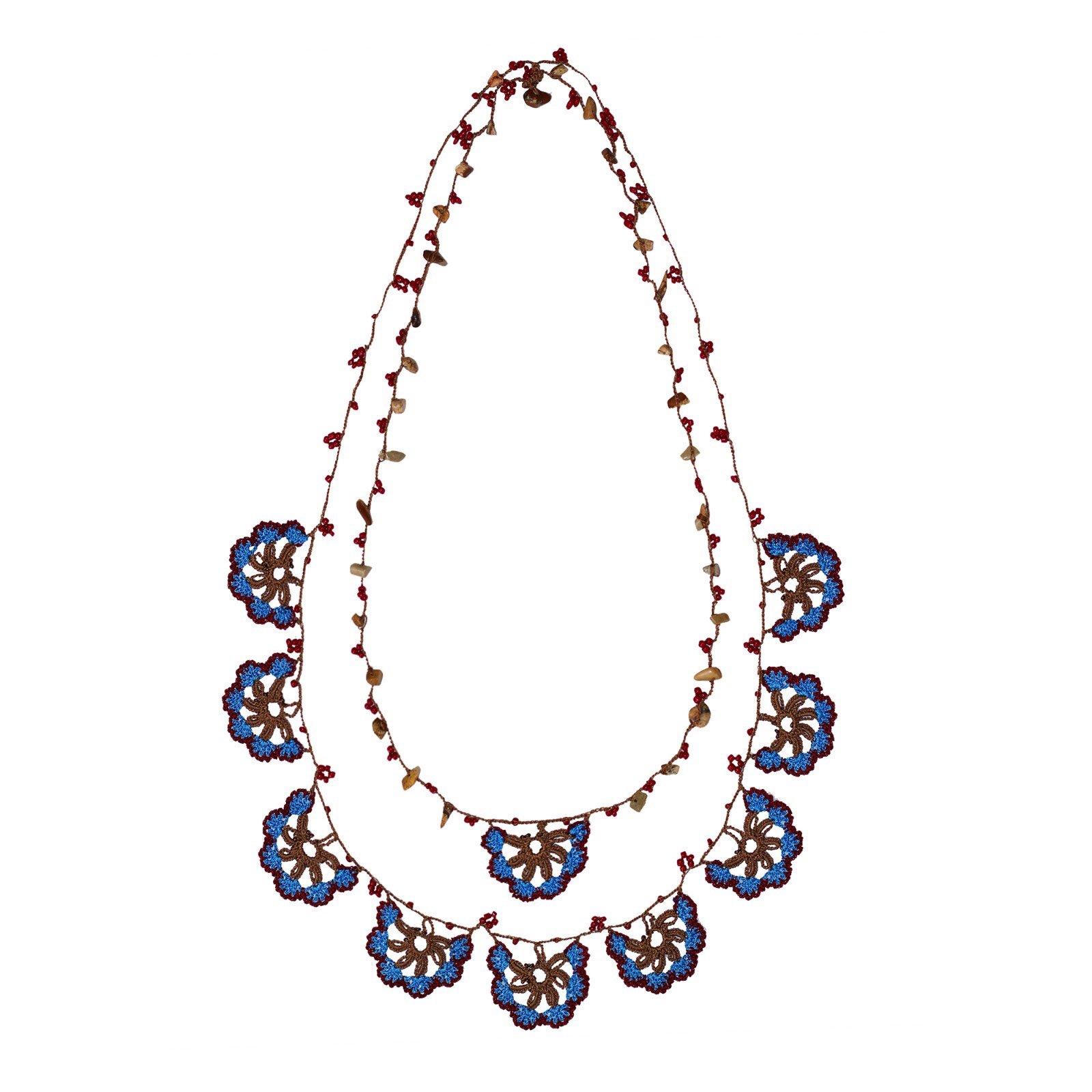 PEDRERA LONG NECKLACE featuring blue and brown hand-embroideries, inspired by Gaudi's La Pedrera, elegantly displayed in a drawstring pouch.