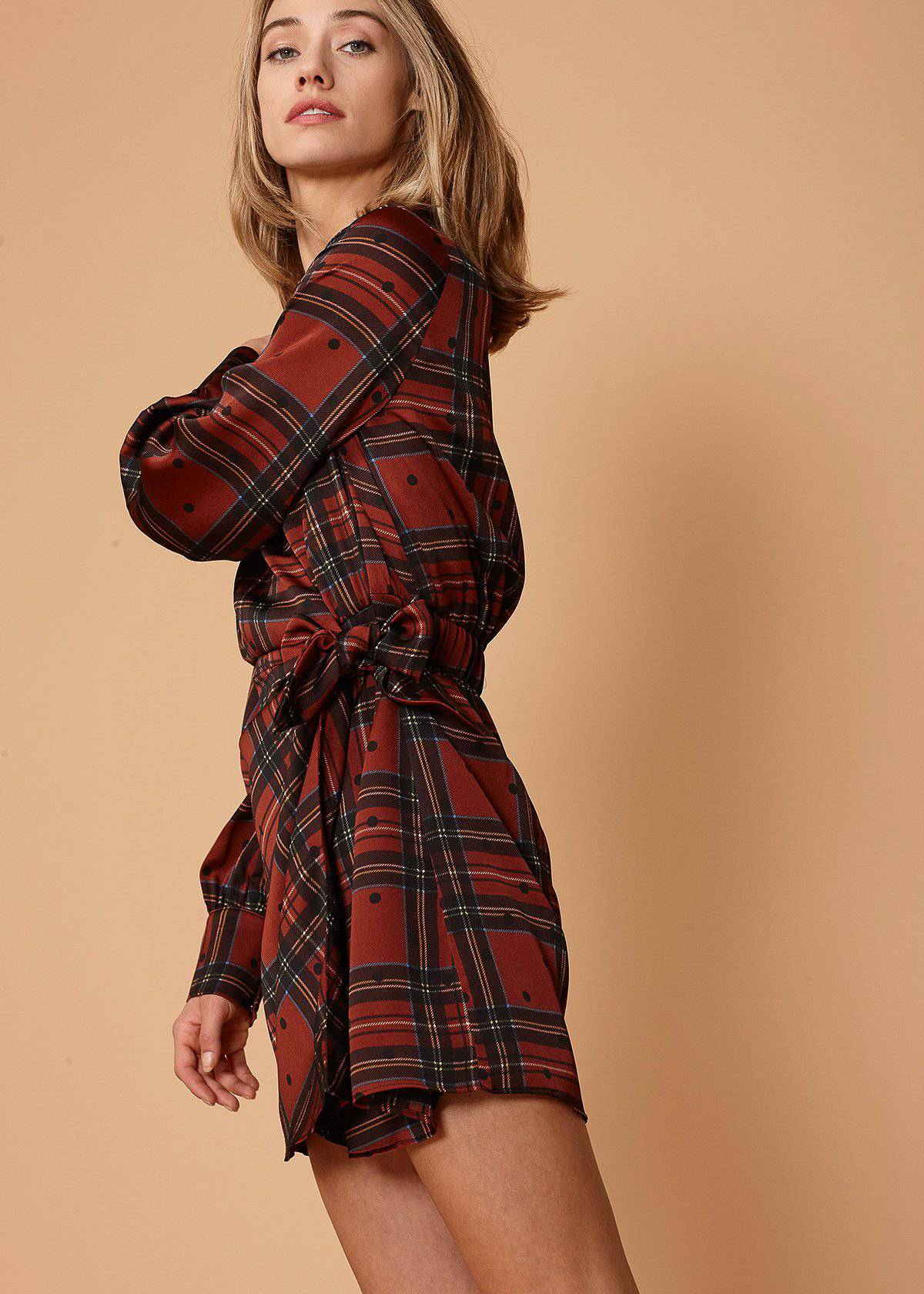 Plaid-Polkadot Mini Wrap Dress in Brick featuring long sleeves and side tie-up detail, showcasing a stylish design.