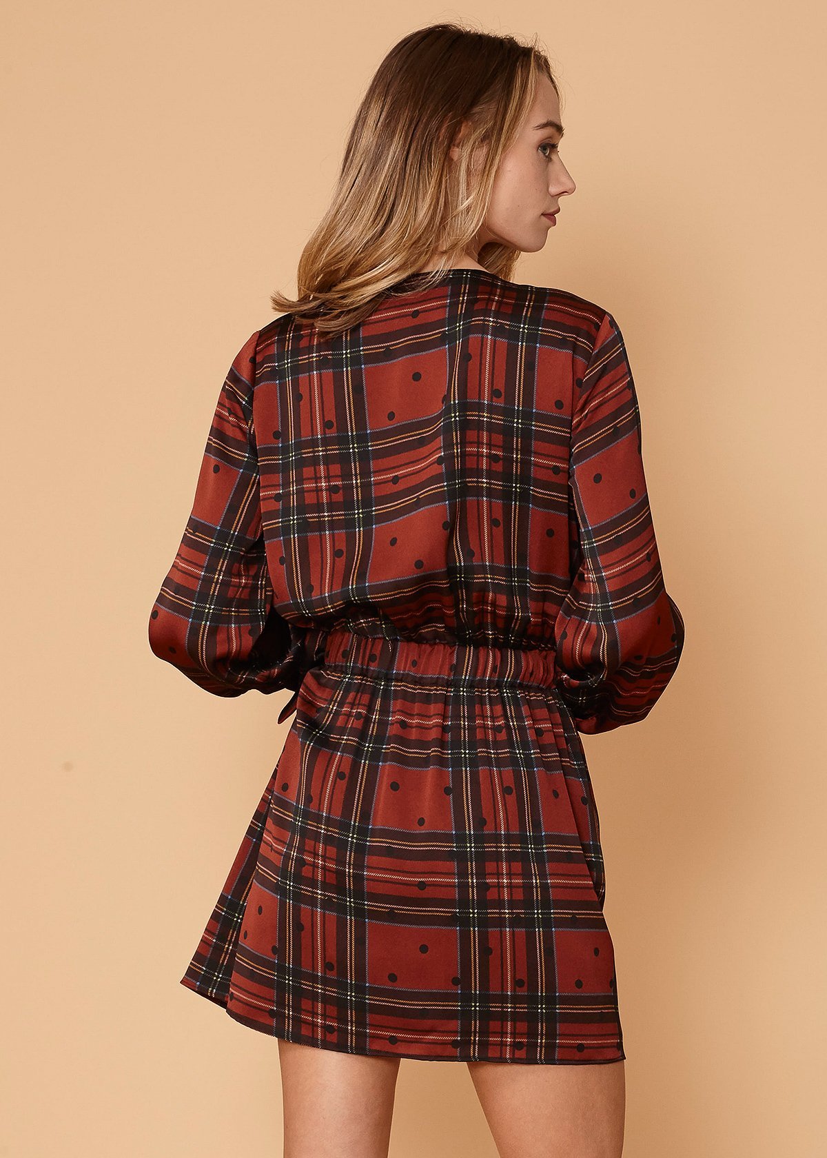 Plaid-Polkadot Mini Wrap Dress in Brick featuring long sleeves and side tie-up detail, showcasing a stylish design.