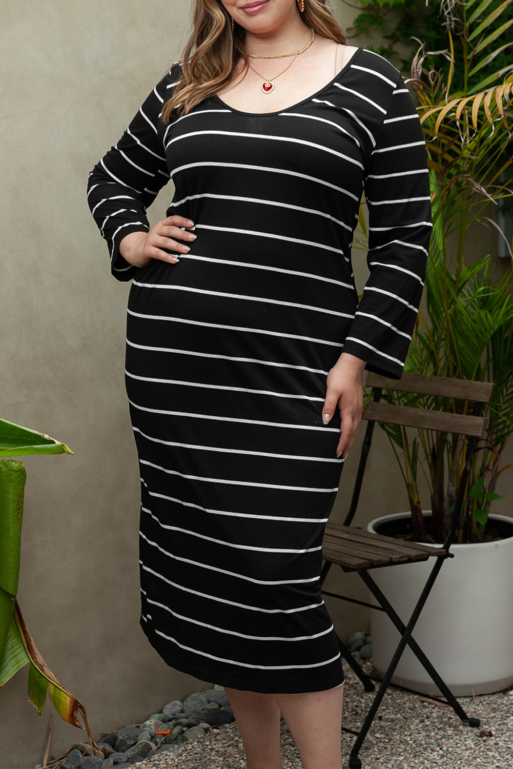 A stylish plus size striped loose shift dress featuring a unique neckline, 3/4 sleeves, and side slits, perfect for casual outings.