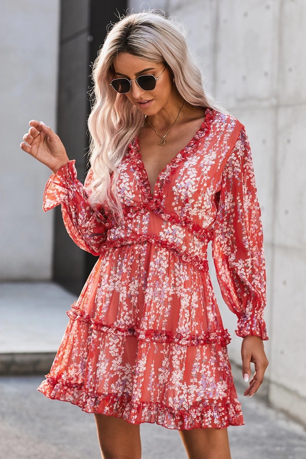 A vibrant red floral dress featuring ruffle detailing, long sleeves, and an open back design, perfect for spring and autumn occasions.