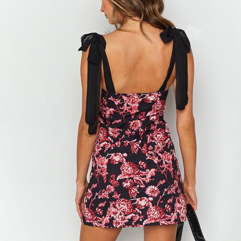 A stylish backless flower printed short dress featuring an elegant bow and bodycon fit, perfect for spring occasions.