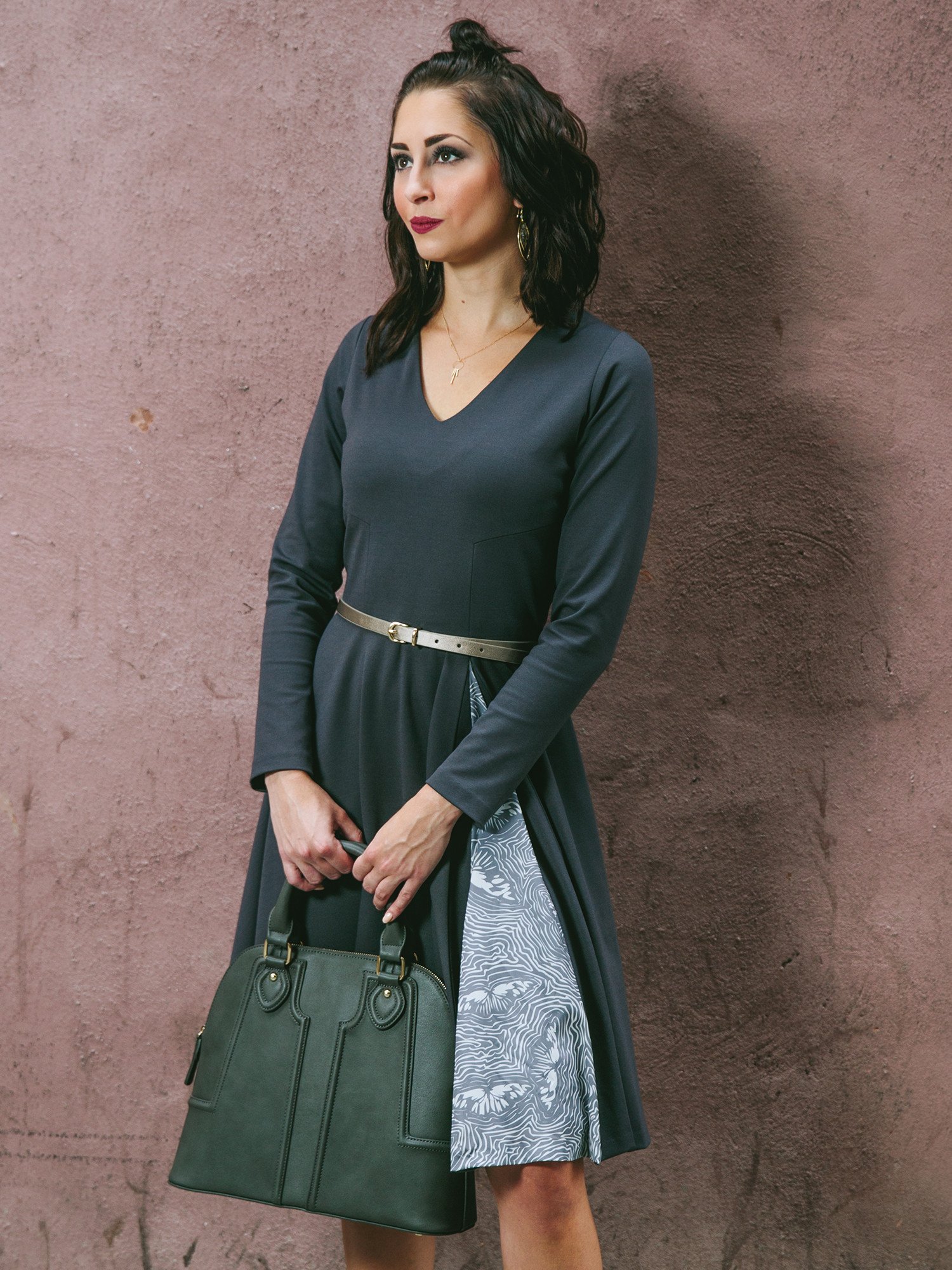 A stylish Swing Dress featuring a butterfly print on a dark background, with a flattering silhouette, V-neck collar, and long sleeves.