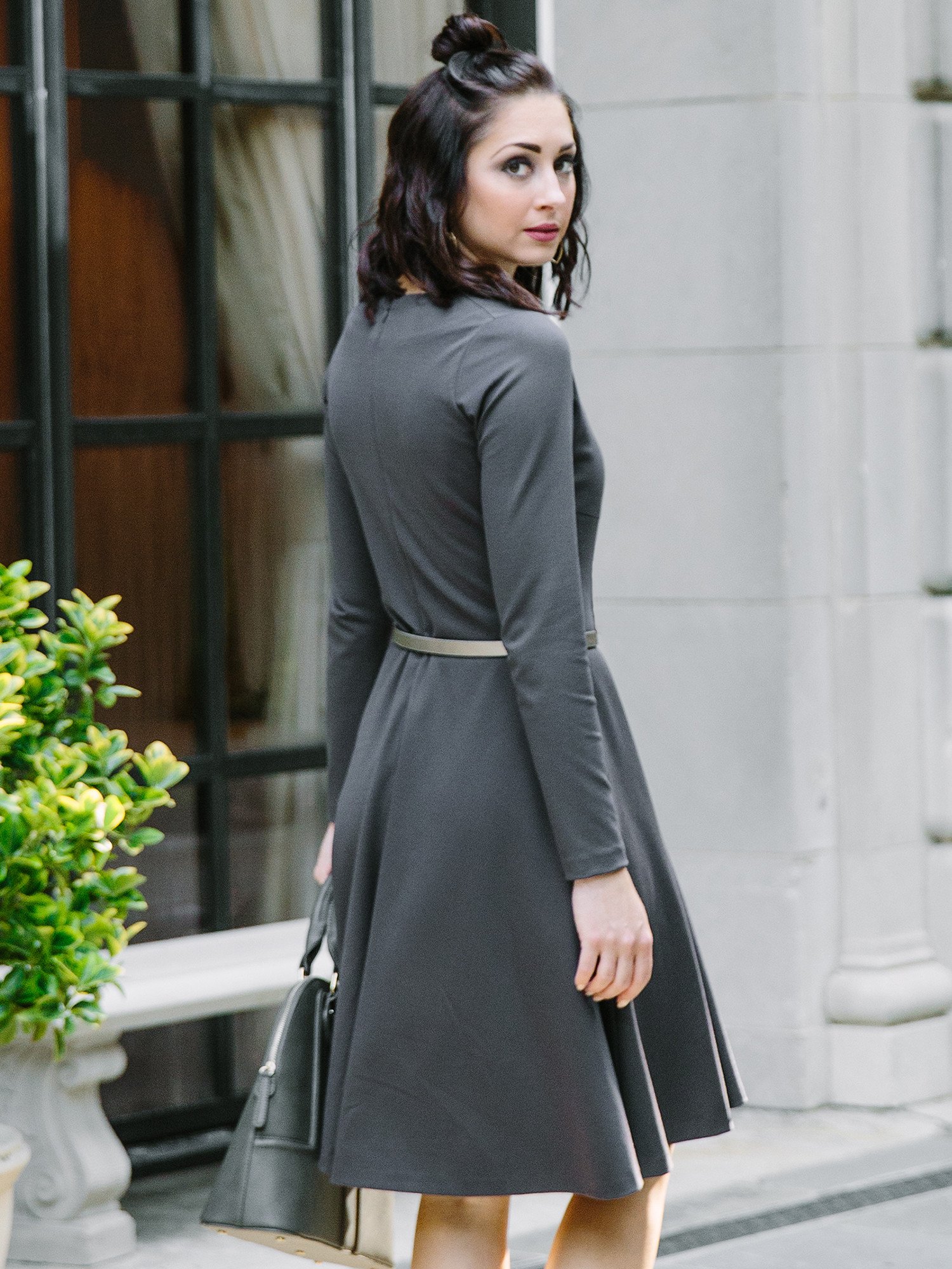 A stylish Swing Dress featuring a butterfly print on a dark background, with a flattering silhouette, V-neck collar, and long sleeves.