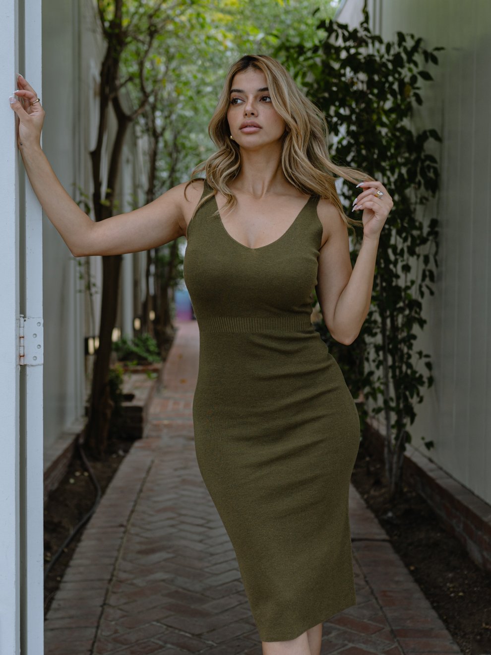 Uptown Knit Midi Dress featuring a ribbed knit texture, plunging v-neckline, and modern block straps, perfect for versatile styling.