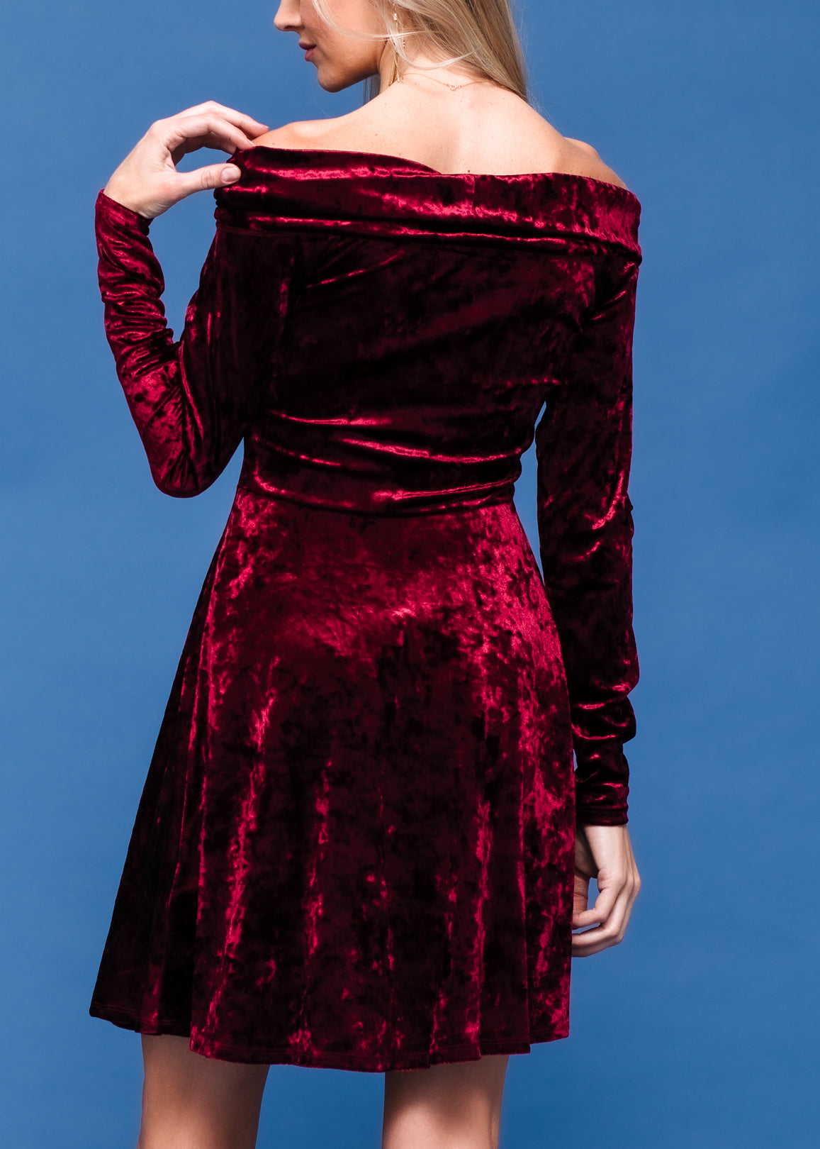 A stylish velvet off shoulder dress with a fitted bodice and heart-shaped neckline, perfect for evening wear.